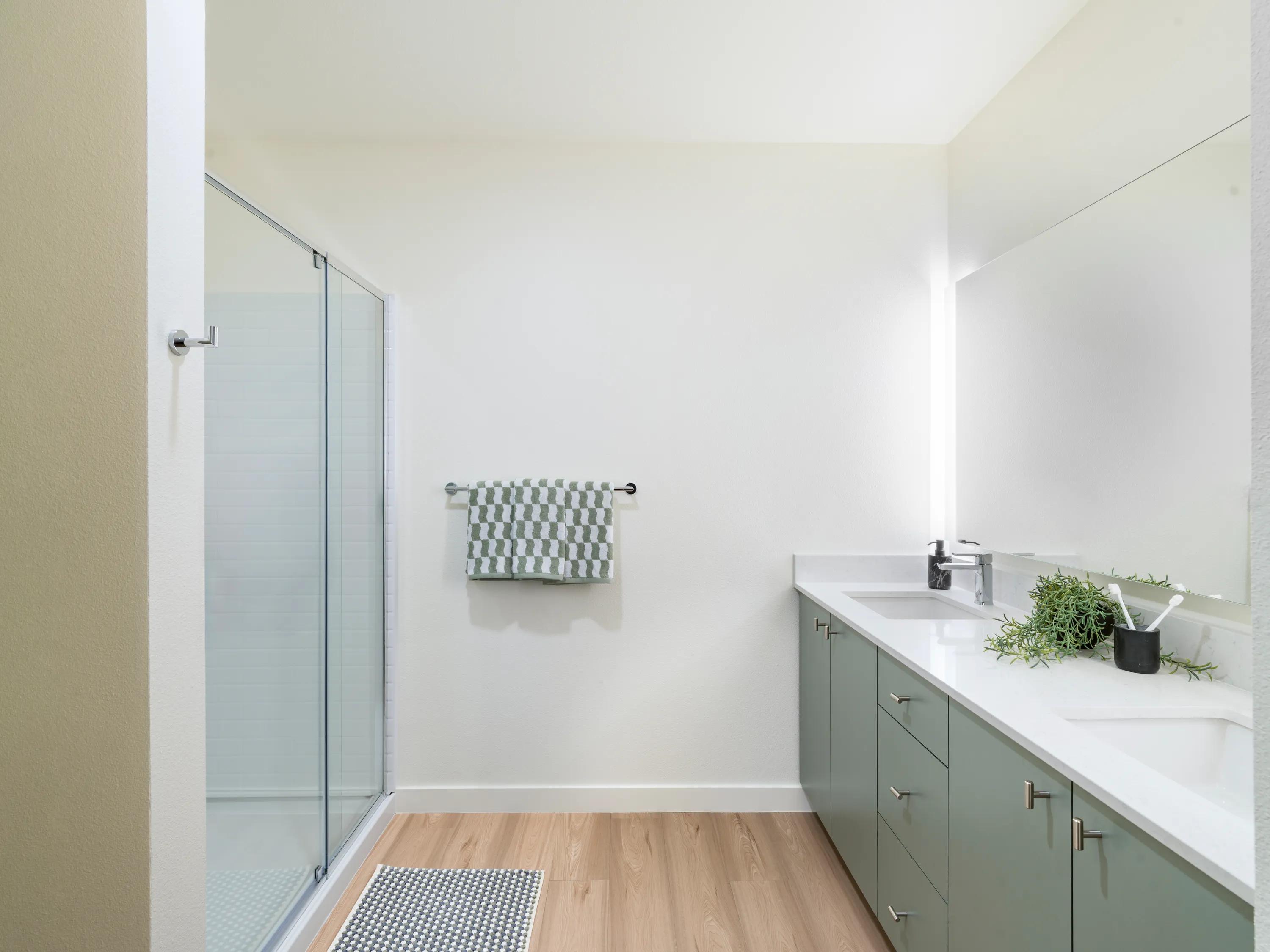 green cabinetry and light brown flooring in bathroom modera beaverton apartment homes for rent in or