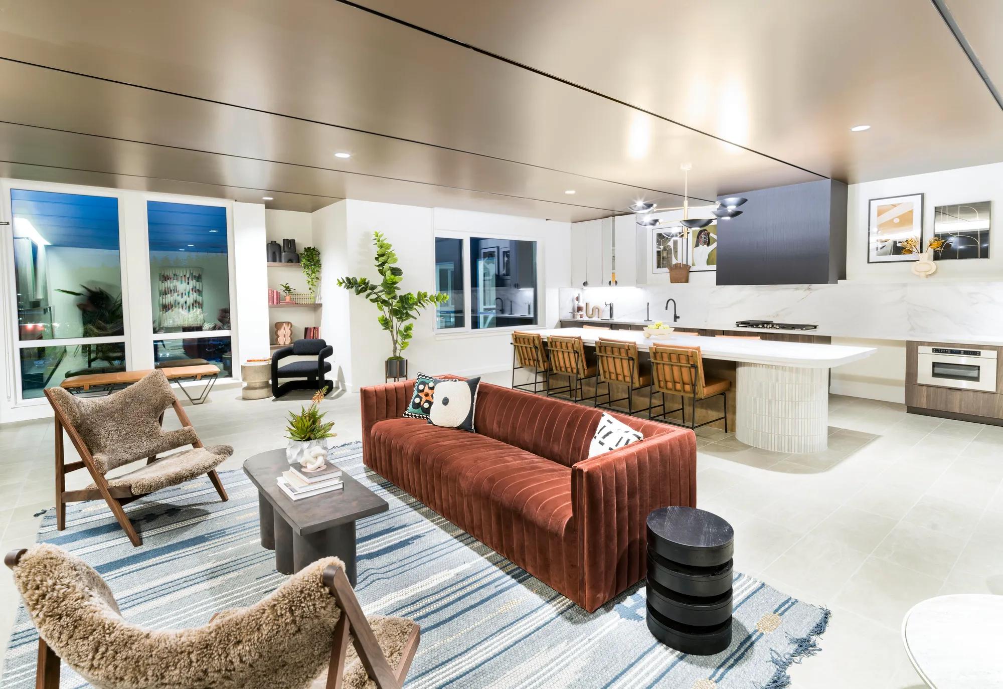 Expansive clubroom with lounge seating, fireplace, and kitchen