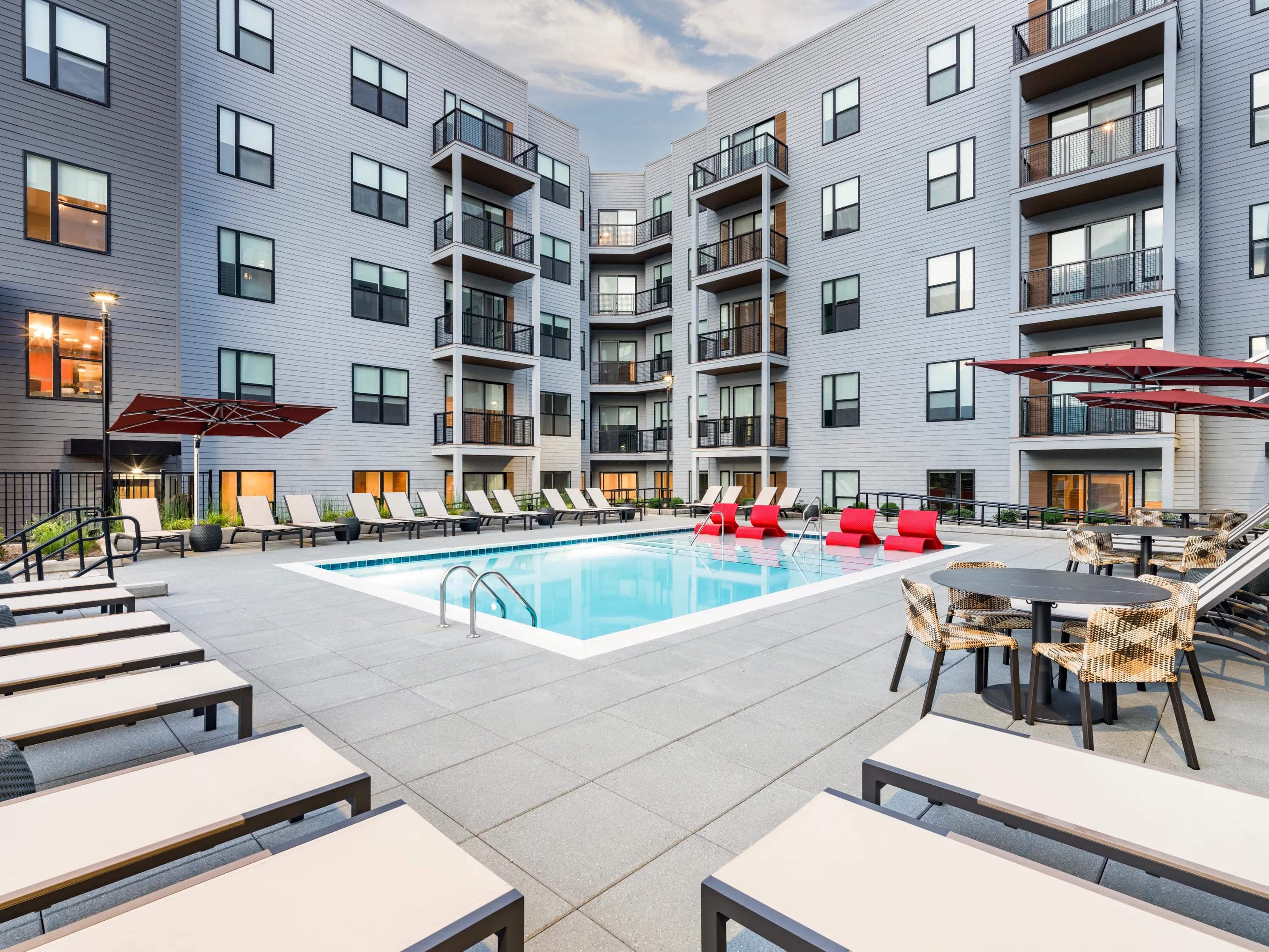 lounge chairs surrounding pool modera loso apartment homes for rent in charlotte nc