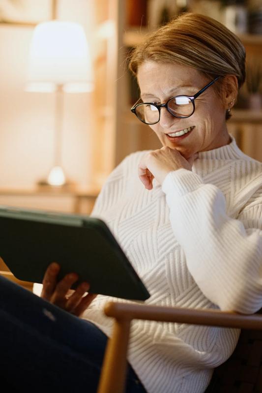 mature woman on tablet modera westside trail apartments in atlanta ga