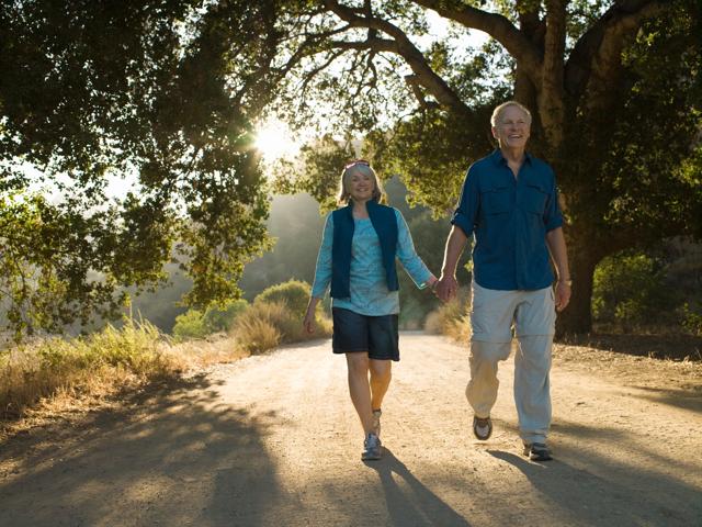 mature couple holding hands while walking in nauture wearing active gear modera walsh heights aledo tx apartments
