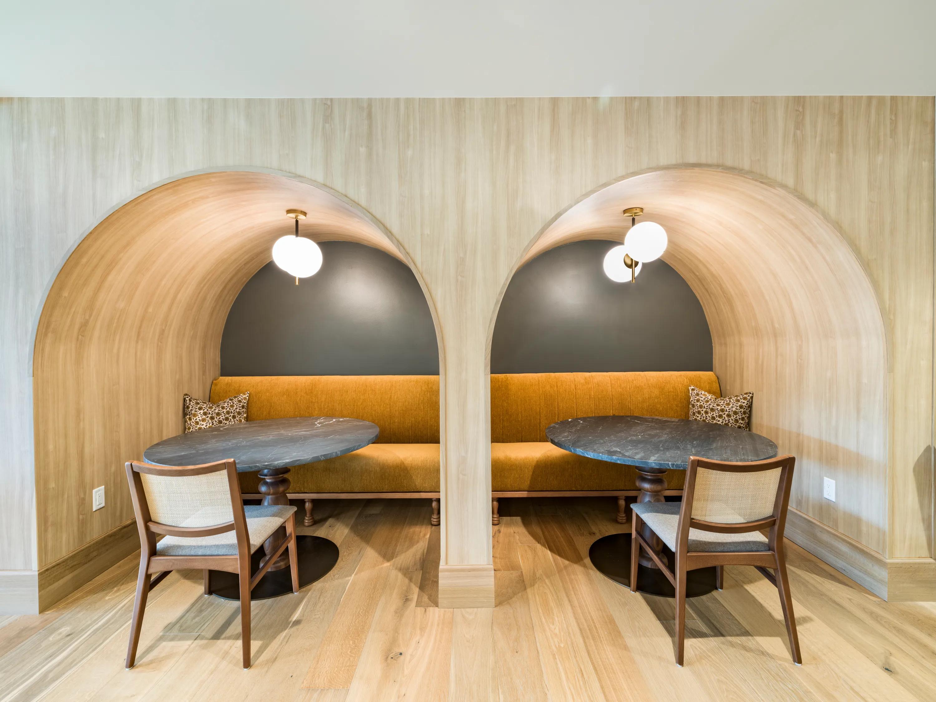 coworking space with large booth seating area at modera university park apartment homes for rent in denver co