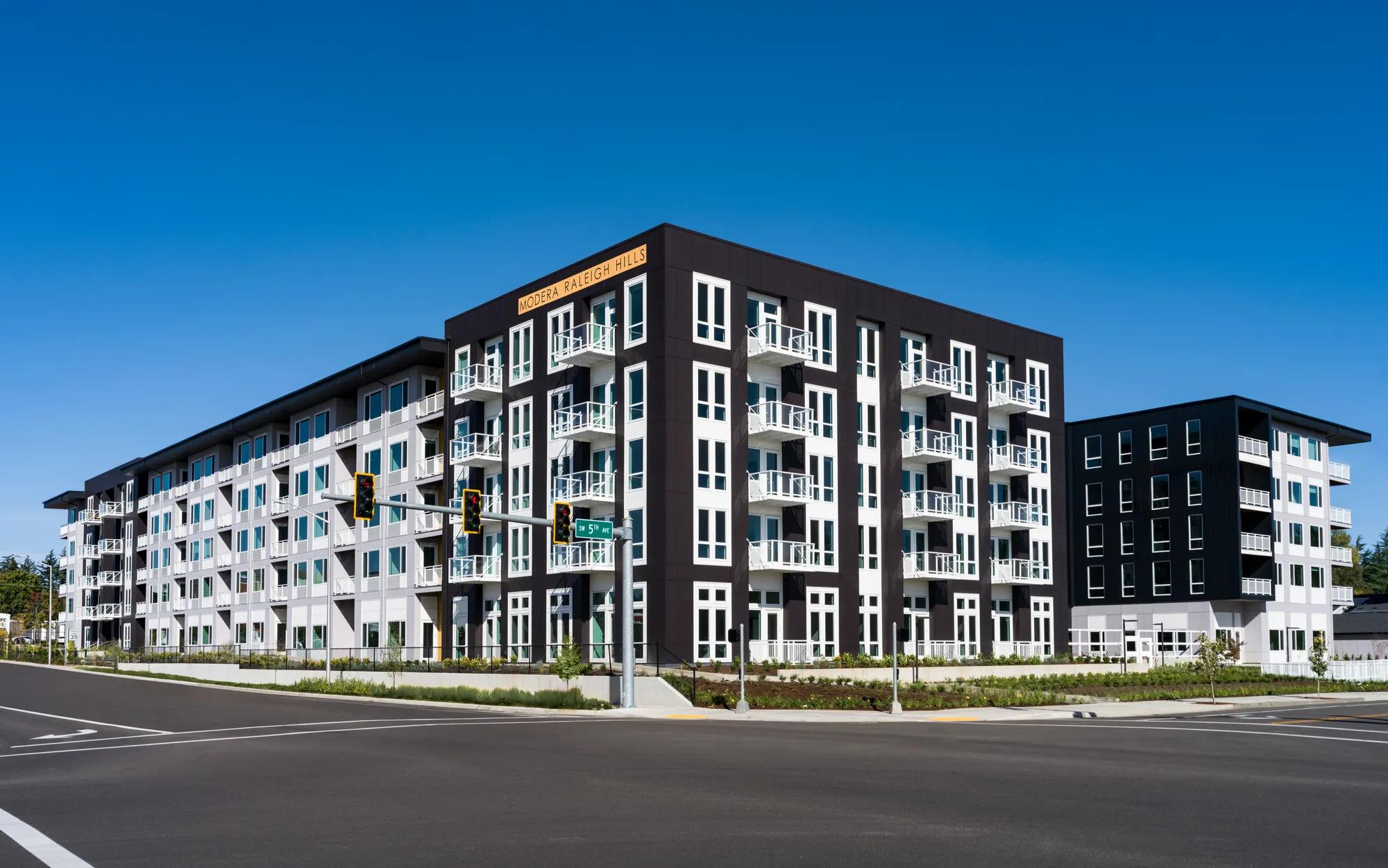 exterior rendering of building with parking at entrance at modera raleigh hills apartment homes for rent in beaverton or