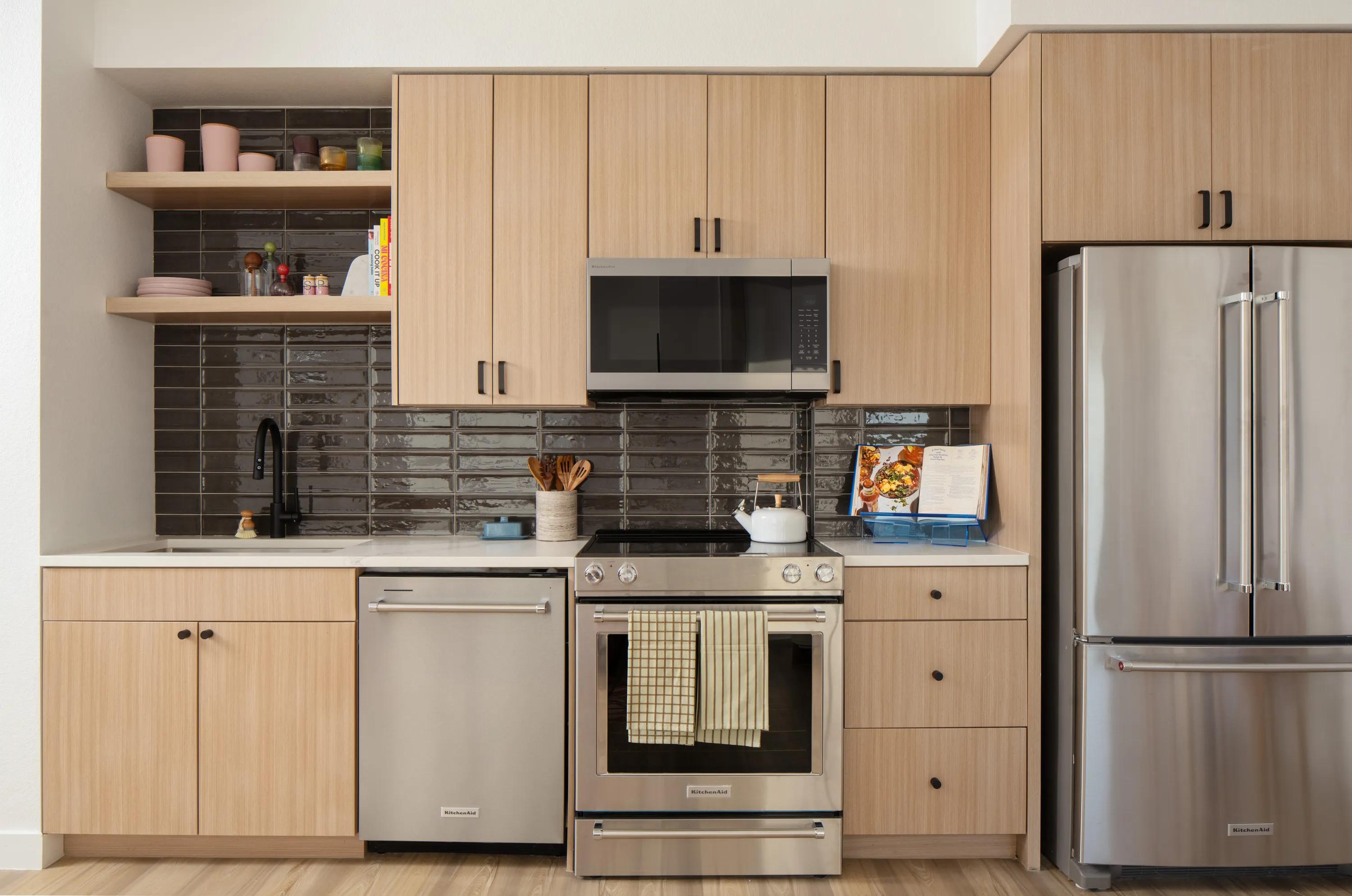 Gourmet kitchens with quartz countertops, custom cabinetry with soft close, and under-cabinet lighting modera rio salado apartments in tempe az