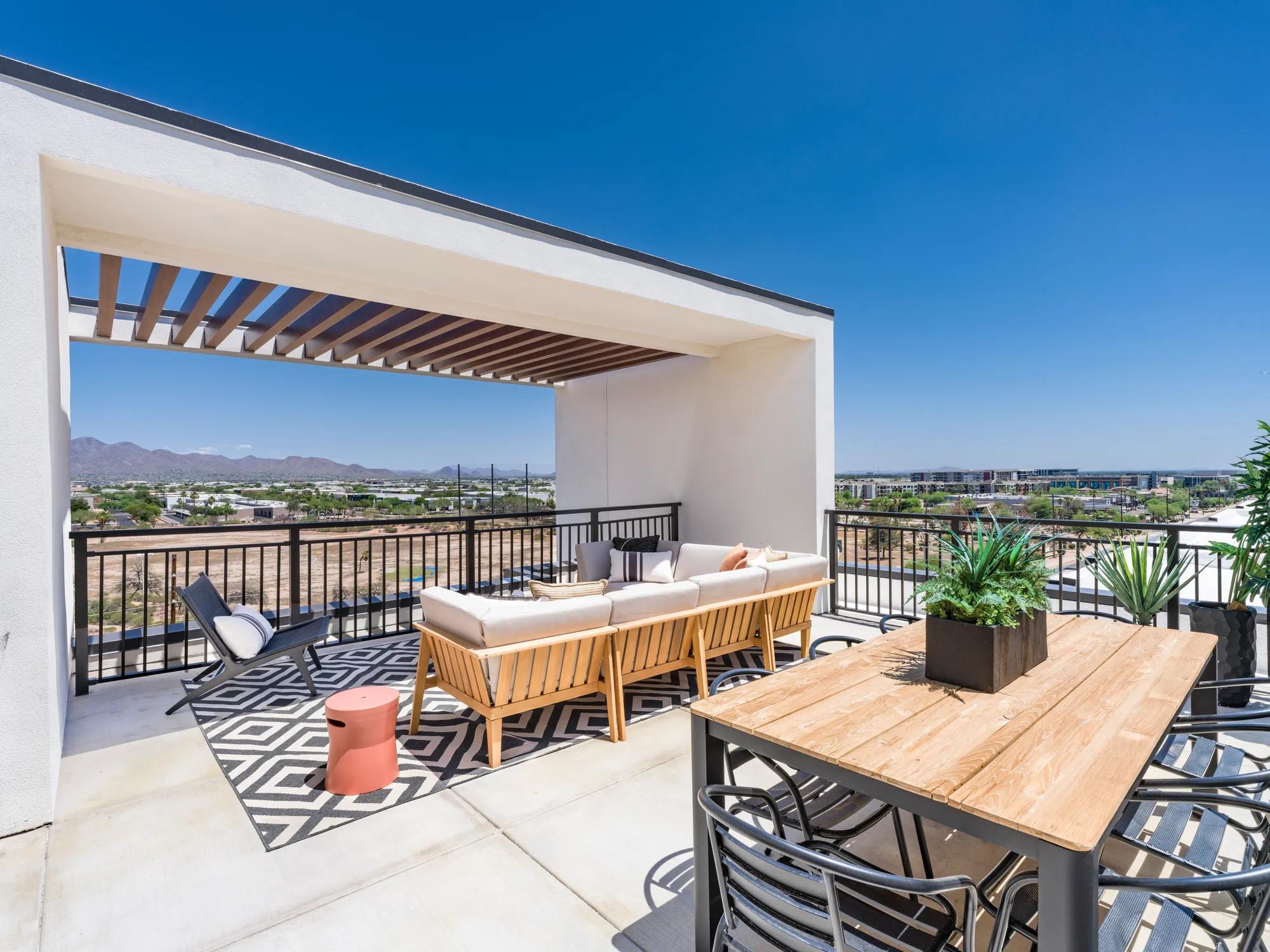 seating on rooftop sunny day with outdoor table dining at modera scottsdale apartment homes for rent in scottsdale az