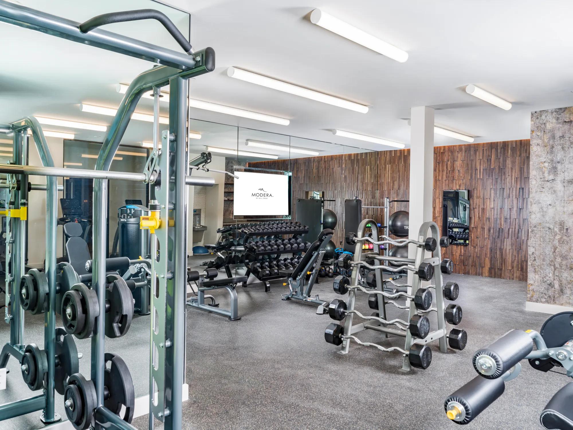Gym with weightlifting equipment at Modera Pomona apartment homes for rent in ca