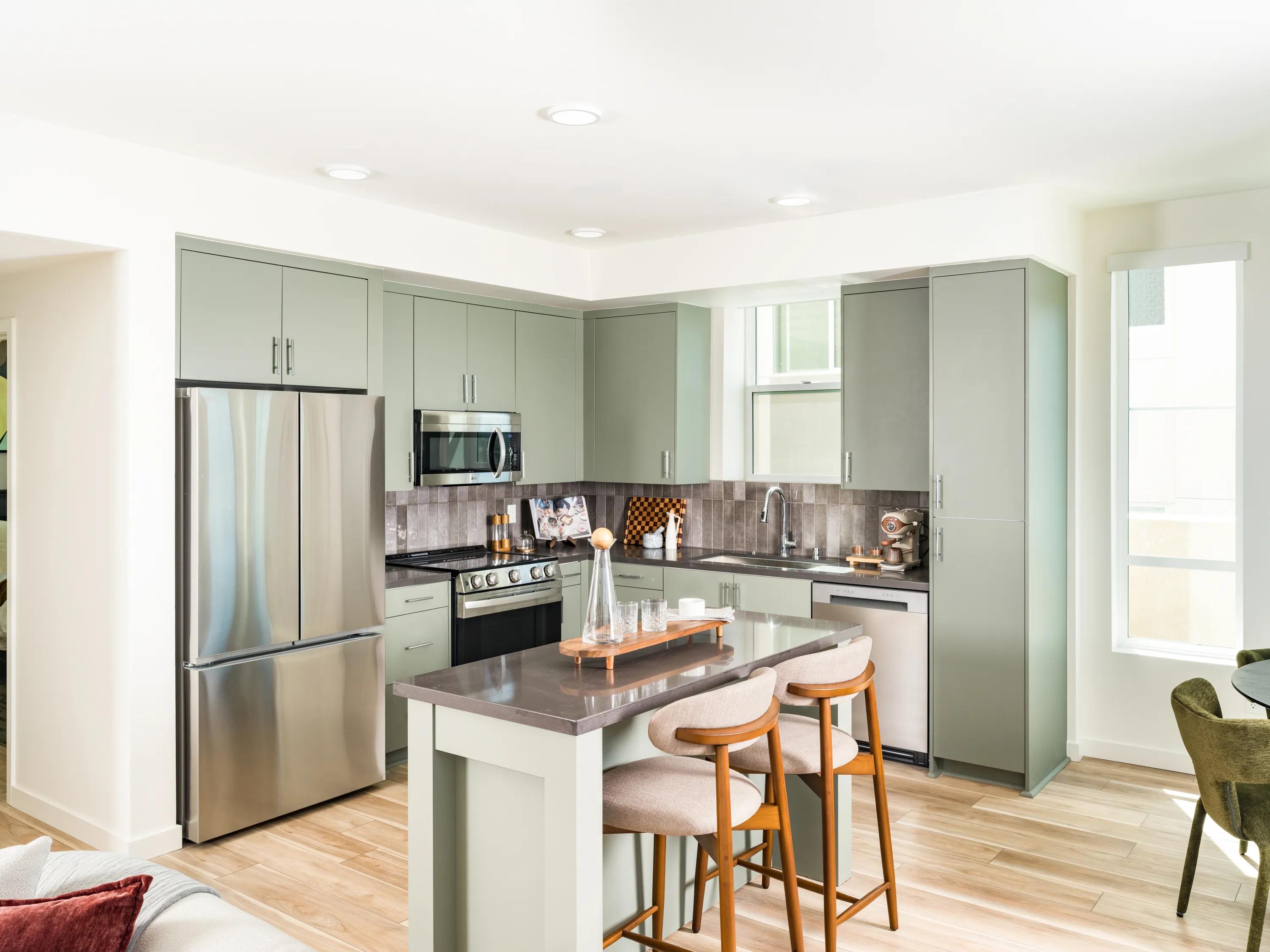 modera melrose apartments in oceanside ca bright kitchen with painted cabinetry and mountain views