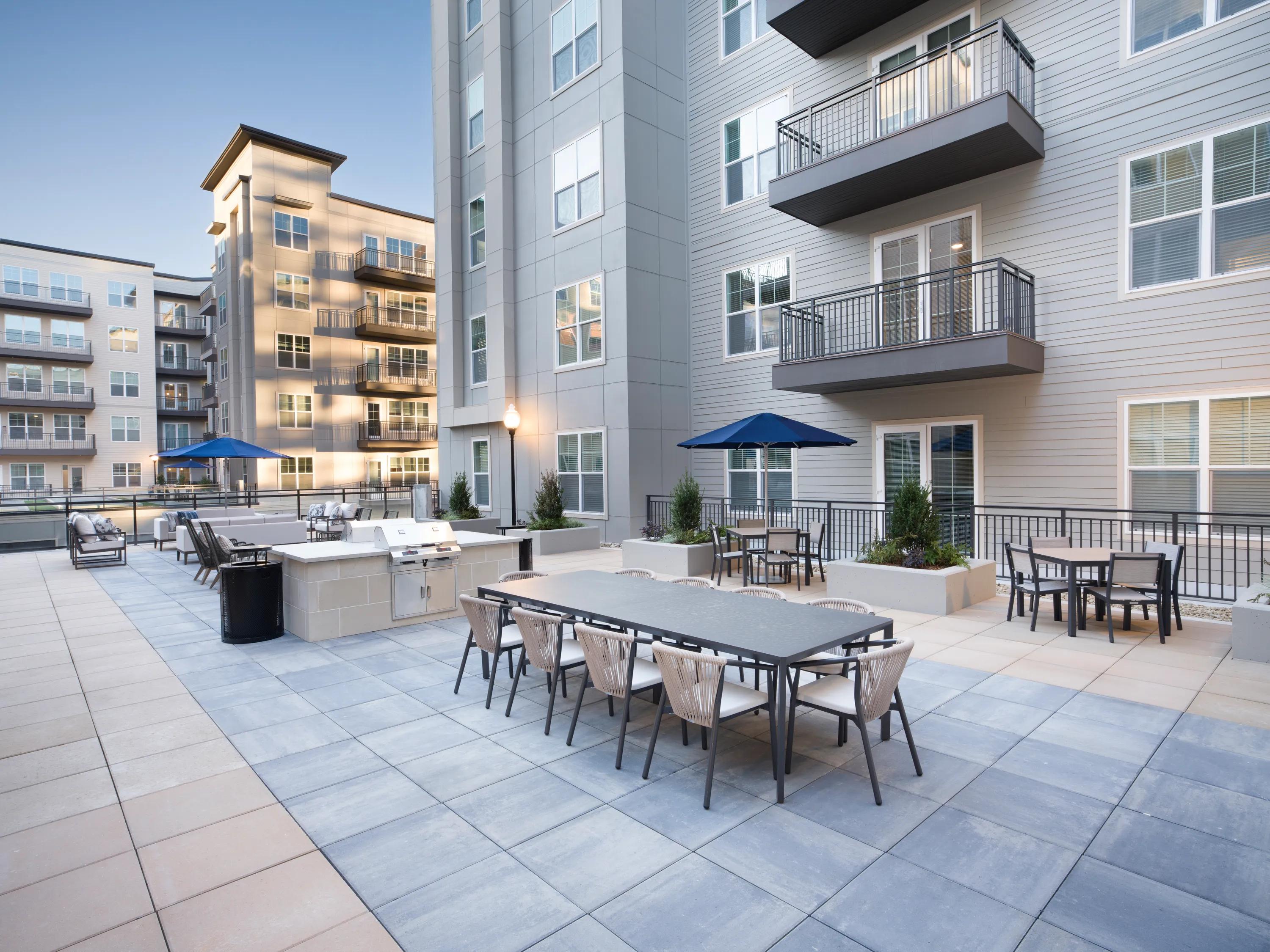 open air courtyard with grilling area and outdoor seating modera liberty row charlotte nc apartments
