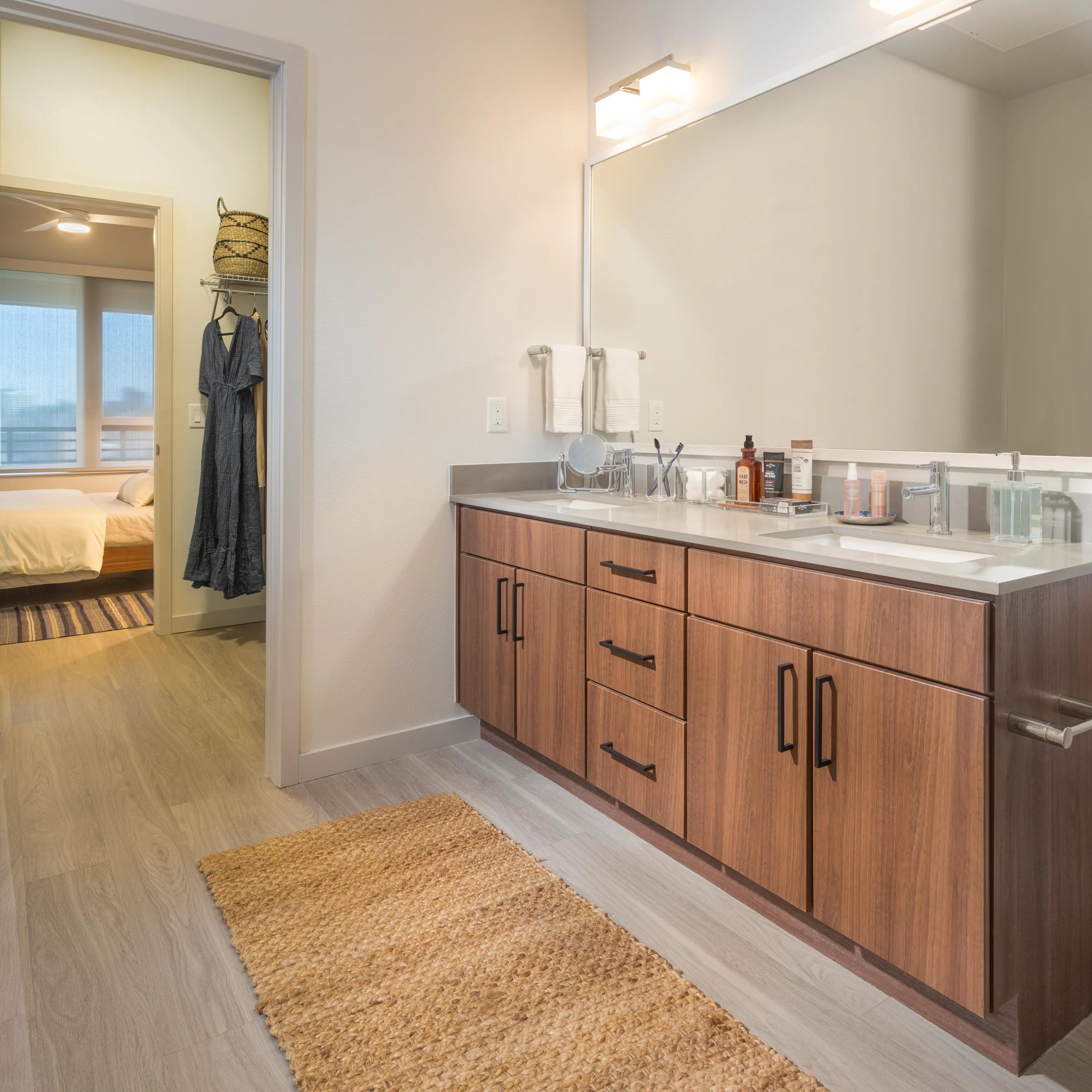 Double sink bathrooms with wood grain vanities modera west wash park denver co