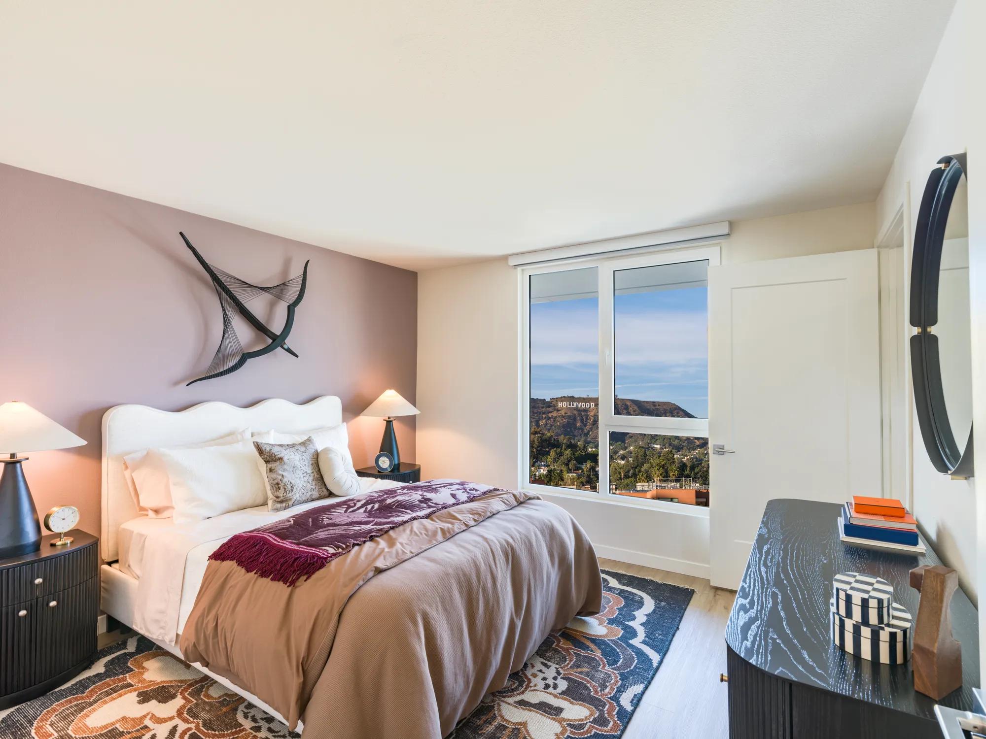 large bedroom with accent wall modera argyle apartments for rent in los angeles ca