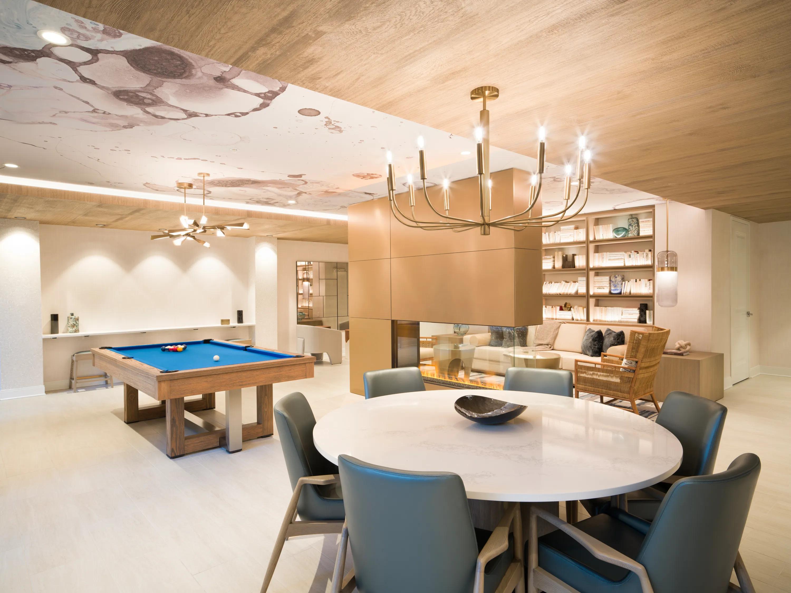 Game room with billiards, poker table, fireplace, and comfortable seating modera liberty row