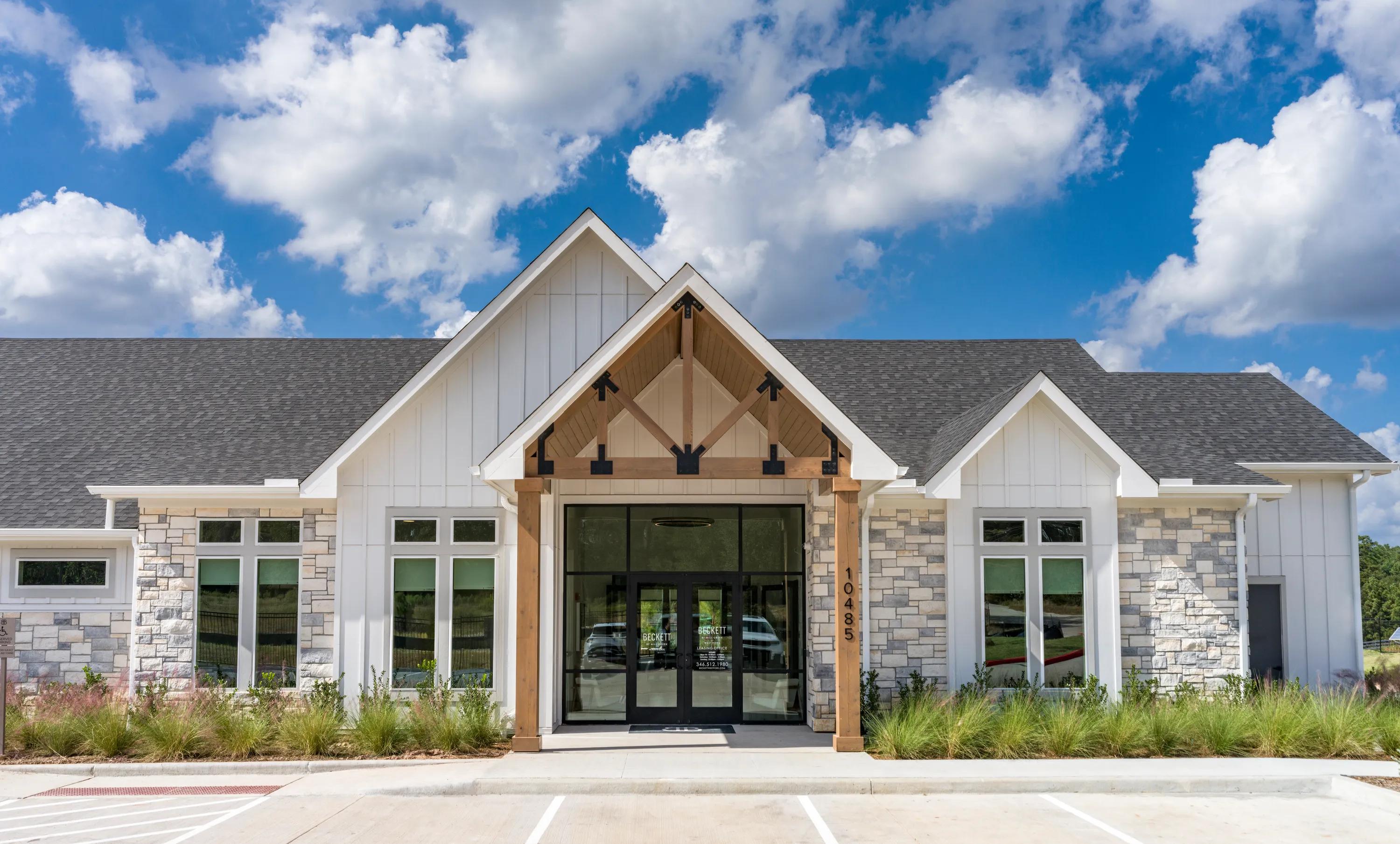 clubhouse leasing office exterior with parking beckett west fork apartment homes for rent in conroe tx
