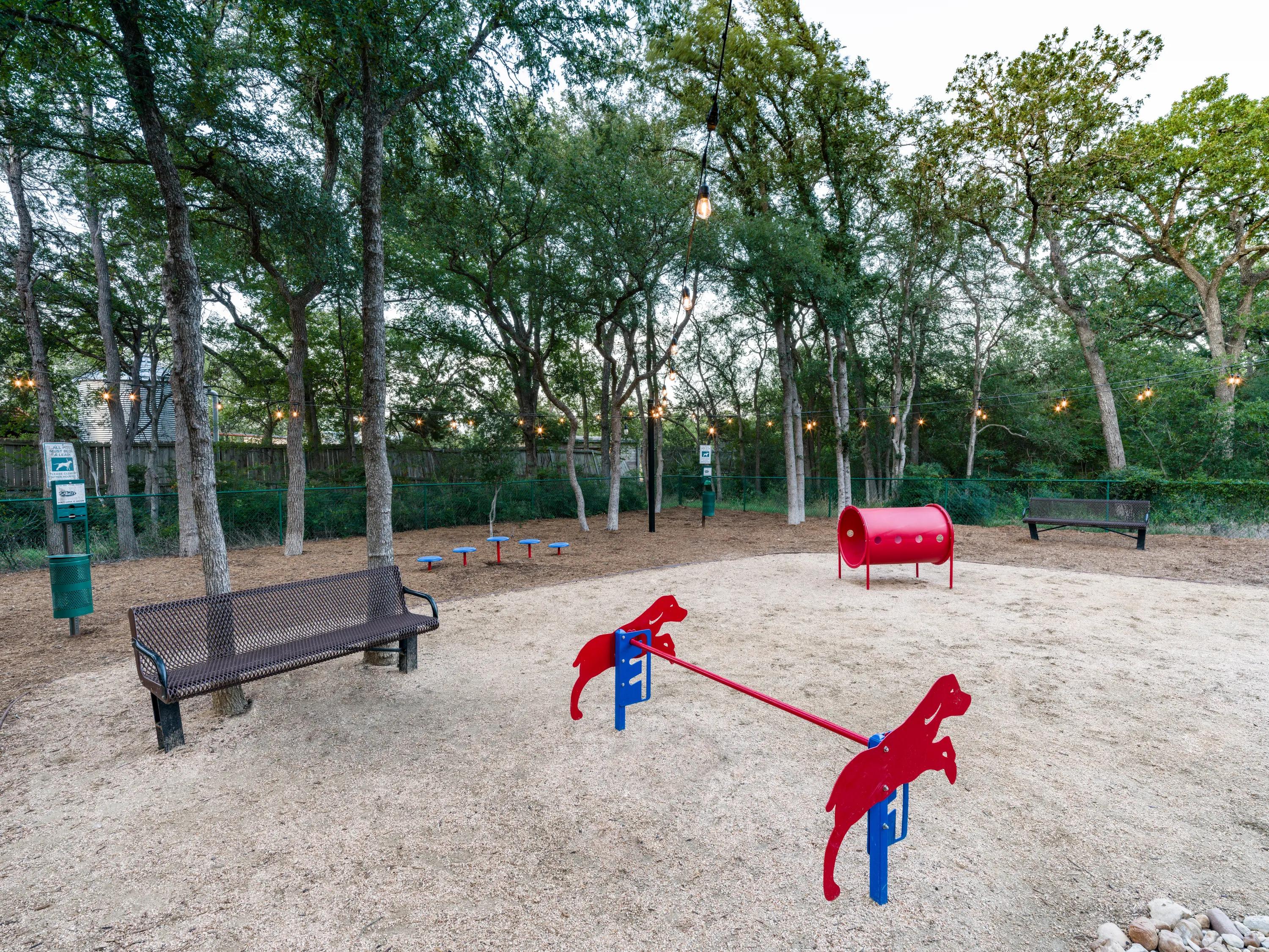 community dog park with outdoor seating alister sunset valley apartment homes for rent in austin tx