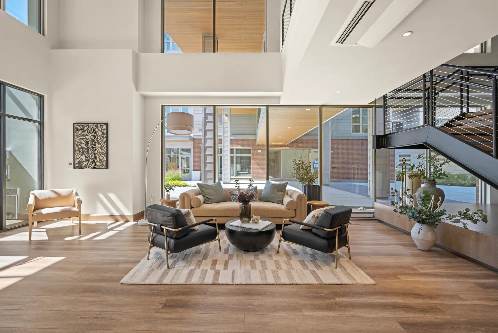 lobby entrance area looking onto courtyard with large windows at modera newton apartment homes for rent in ma