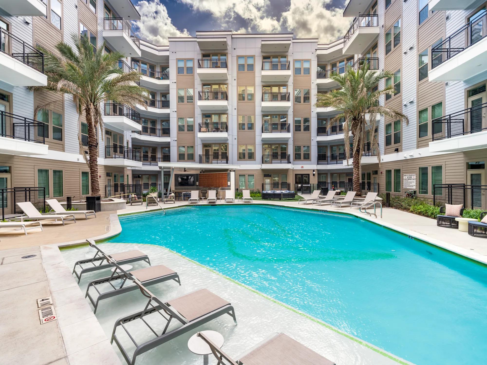 poolside loungeing at modera garden oaks apartments houston tx
