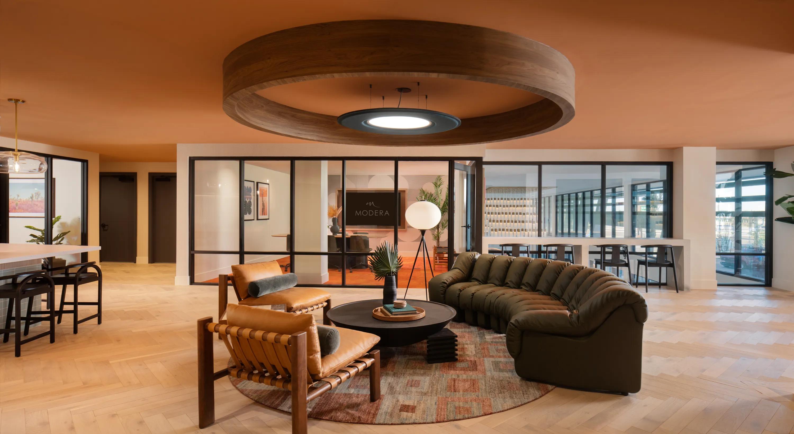 Coworking space with private work stations, comfortable seating areas, and a conference room