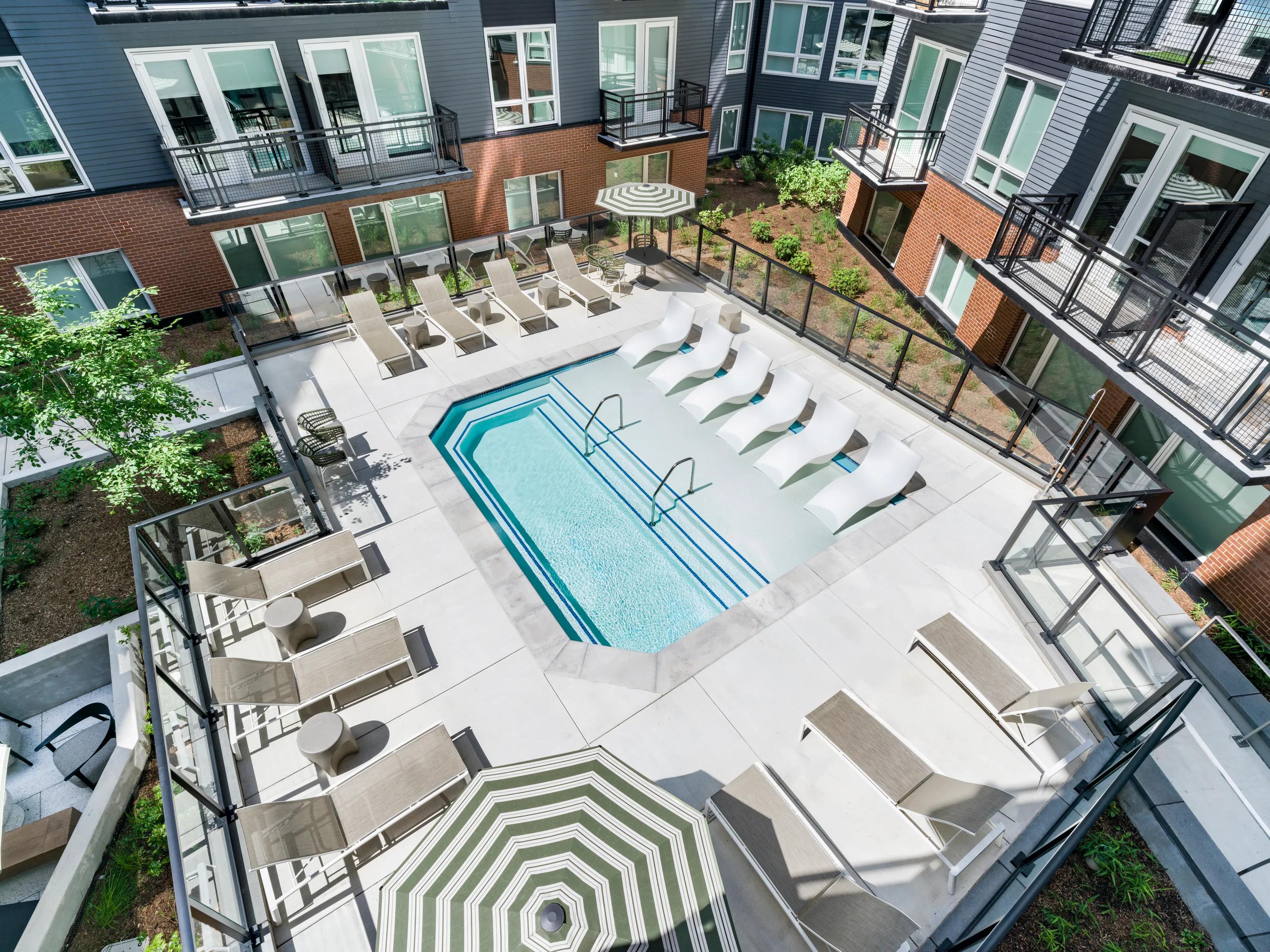 courtyard and pool with lounge seating modera h street apartment homes for rent in washington dc