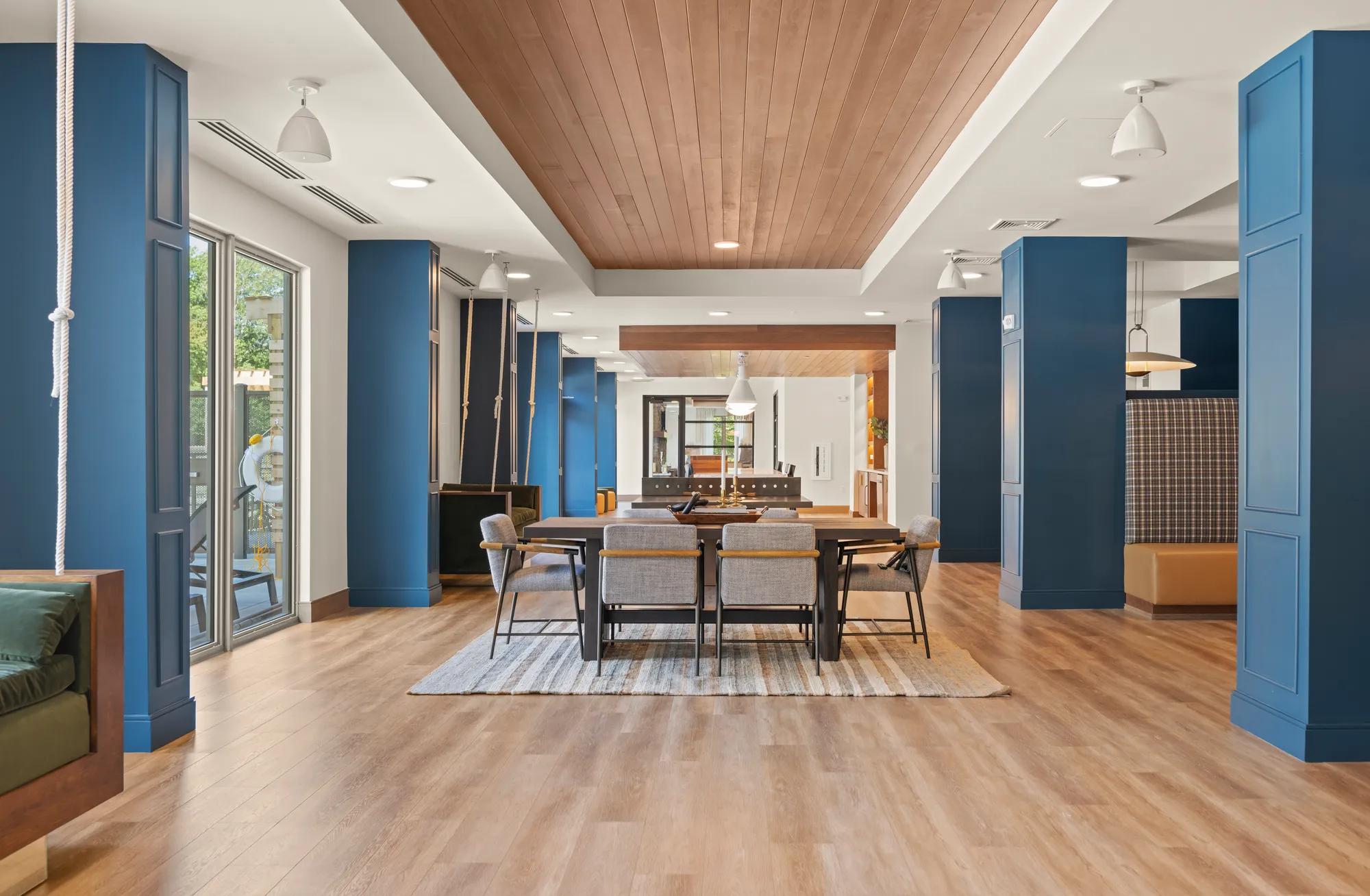 clughouse game room with tasteful decorations and blue and white walls at modera newton apartment homes for rent in ma