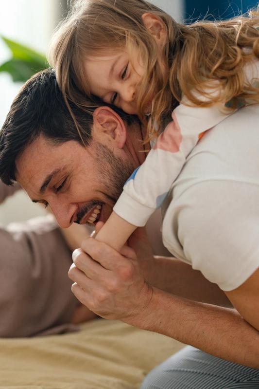 Father with young daughter over his shoulders