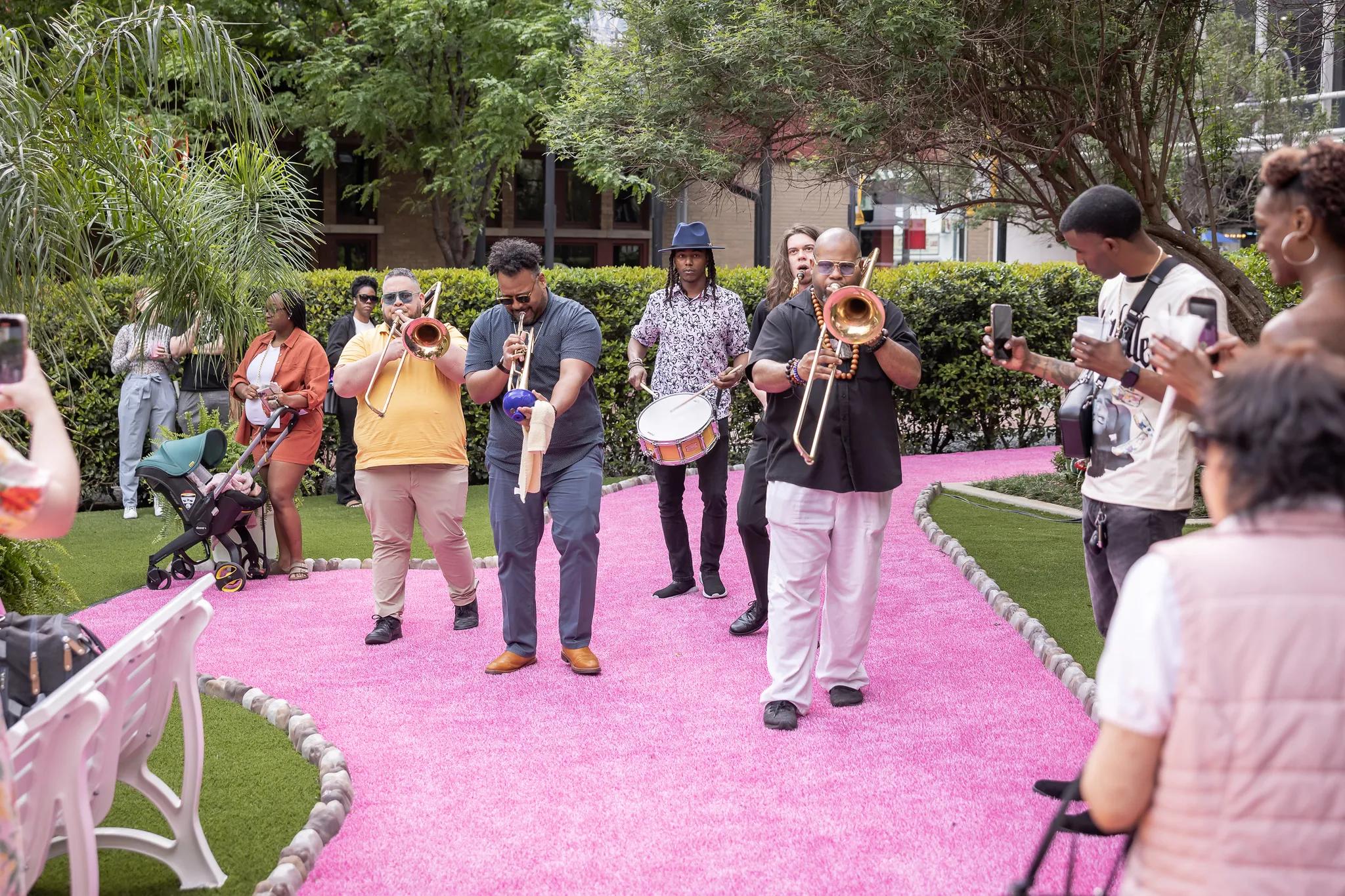 live jazz band performing outside on pink sidewalk in dallas tx modera st paul apartments