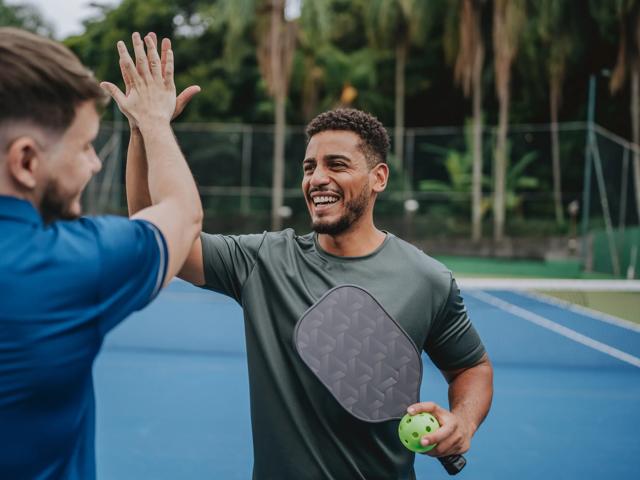 pickleball players high fiving alister quincy
