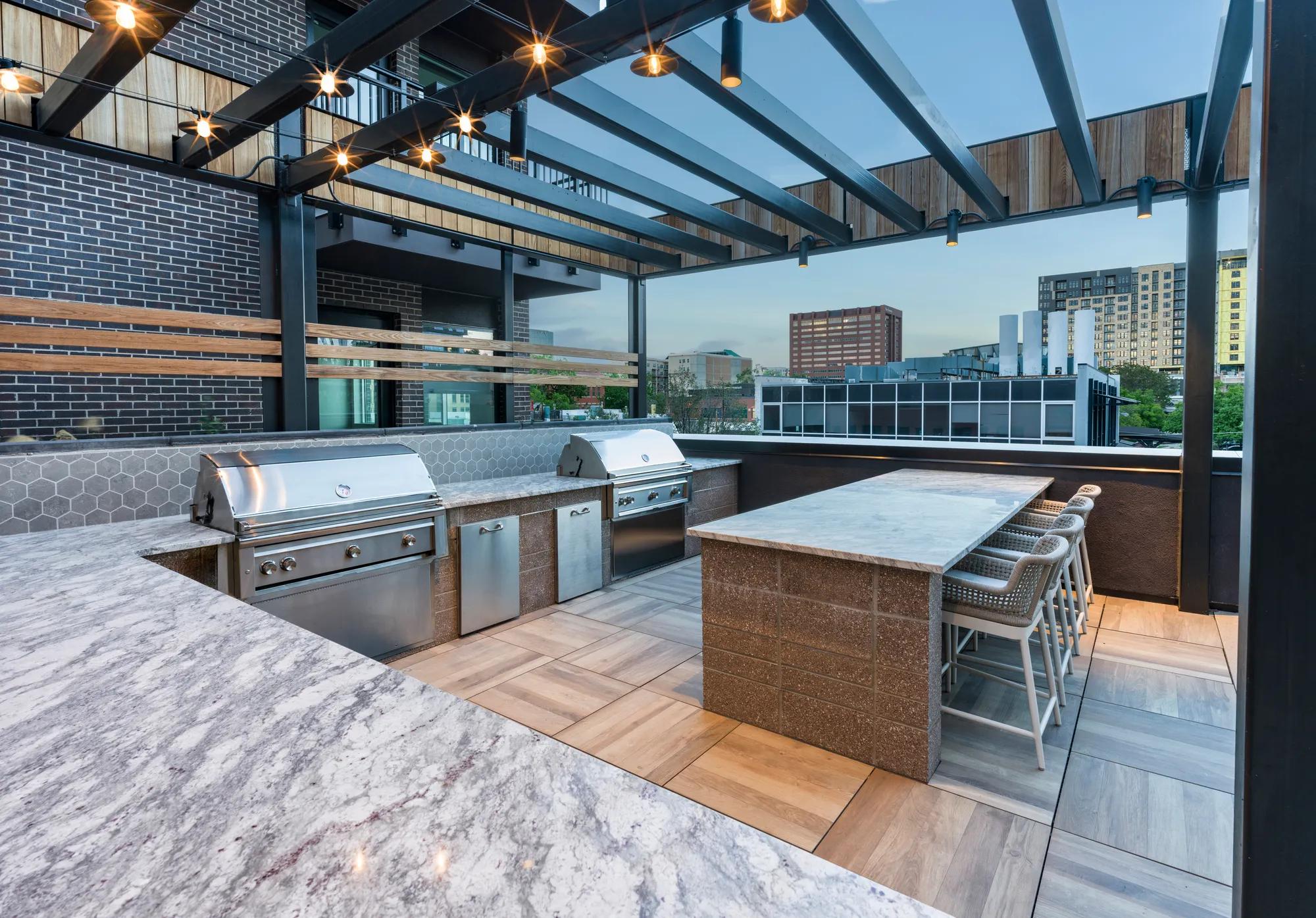 bbq area with stainless steel and high end countertops modera golden triangle apartment homes for rent in denver co