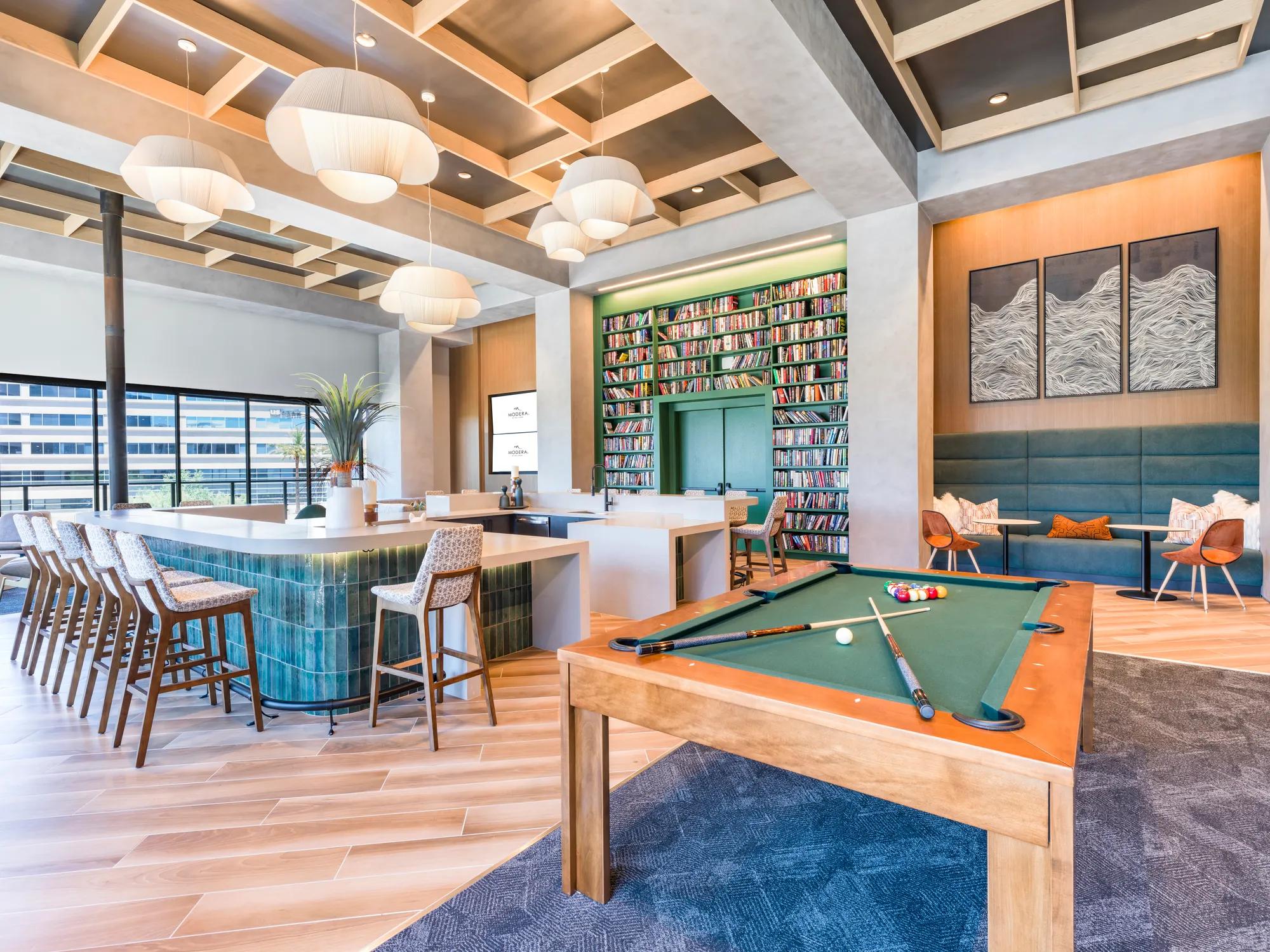 pool table and demonstration ktichen with seating in clubhouse at modera scottsdale apartment homes for rent in scottsdale az