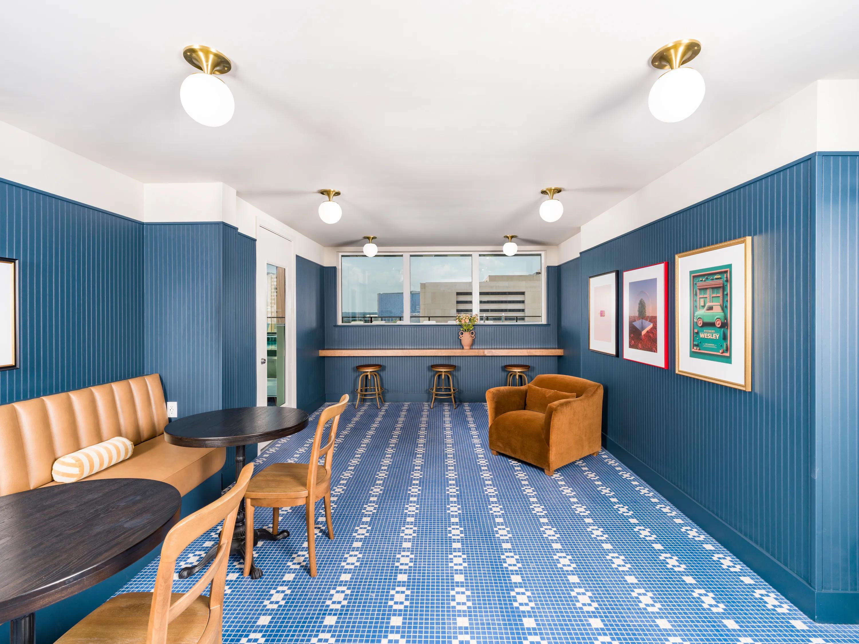 large clubroom with seating and fireplace and window lined wall rendering modera st. paul apartment homes for rent in dallas tx