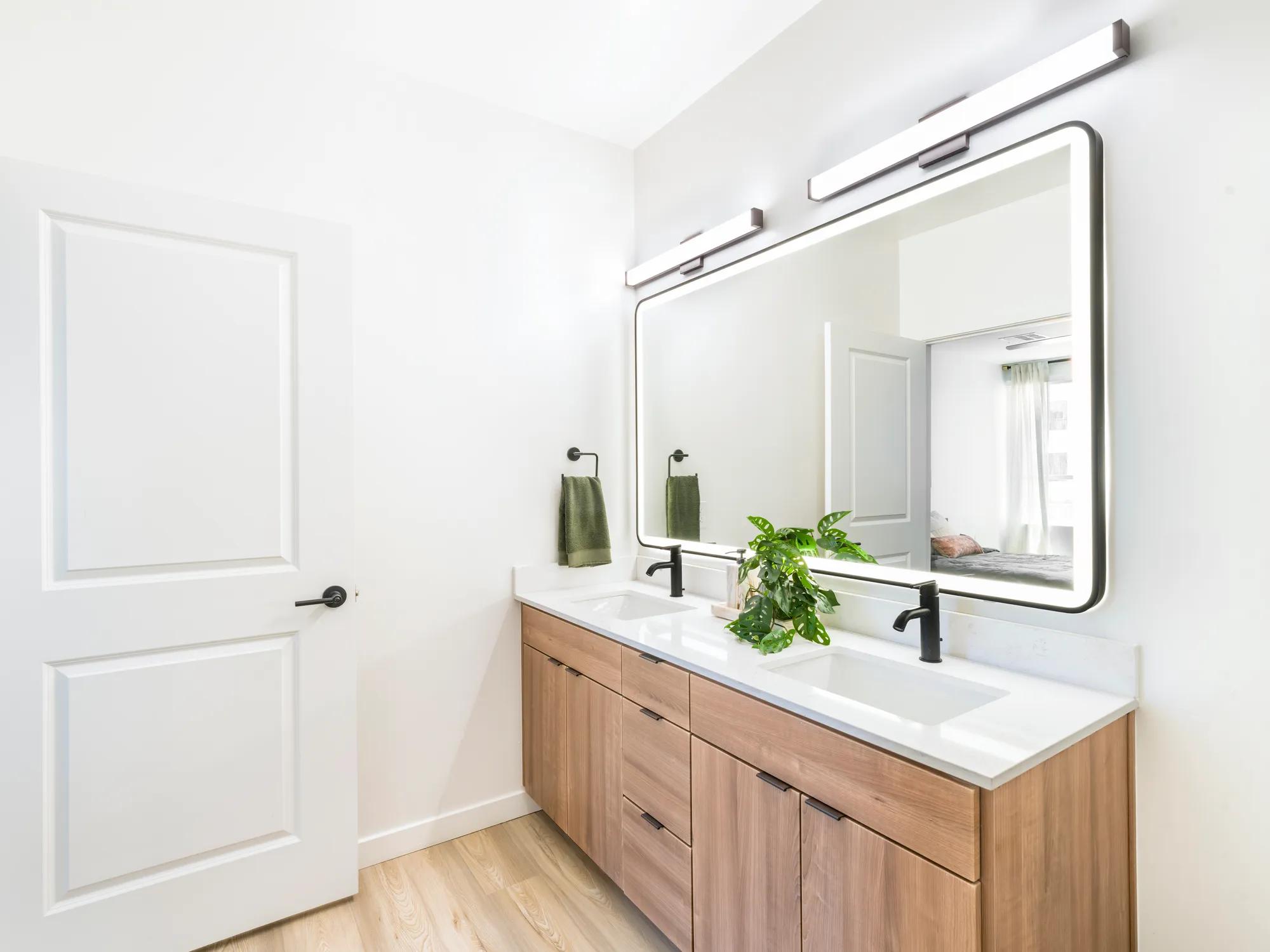 bathroom with double vanity and backlit mirror modera higley commons apartment homes for rent in gilbert az