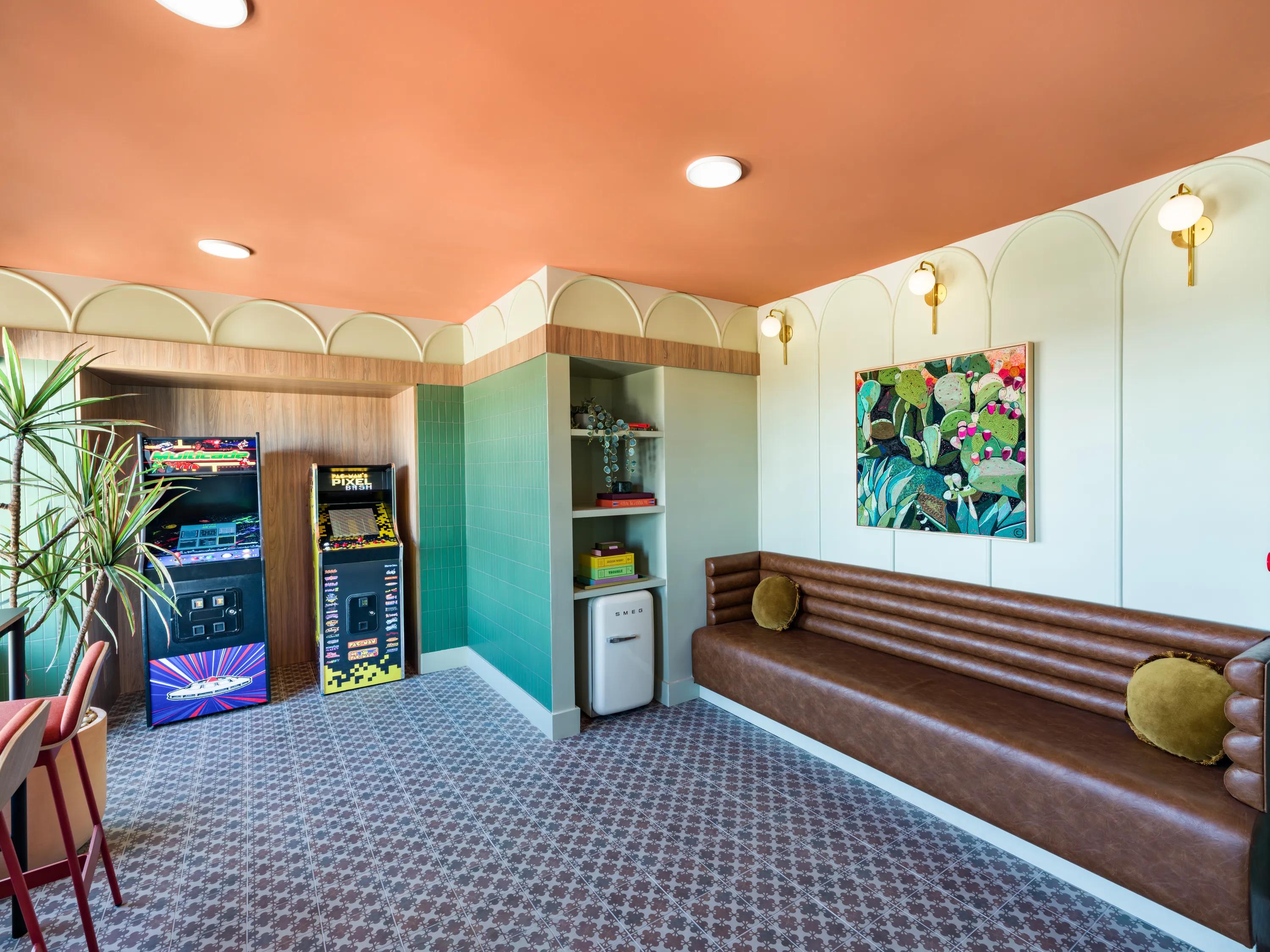 retro lounge with orange ceiling and leather sofa modera st paul apartment homes for rent