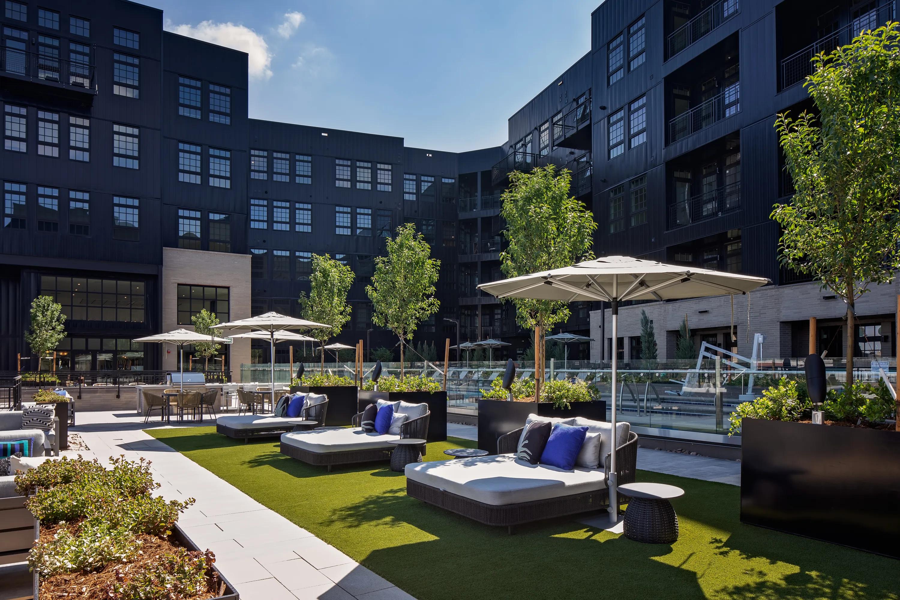 pool deck and courtyard with lounge seating modera art park apartment homes for rent in denver colorado