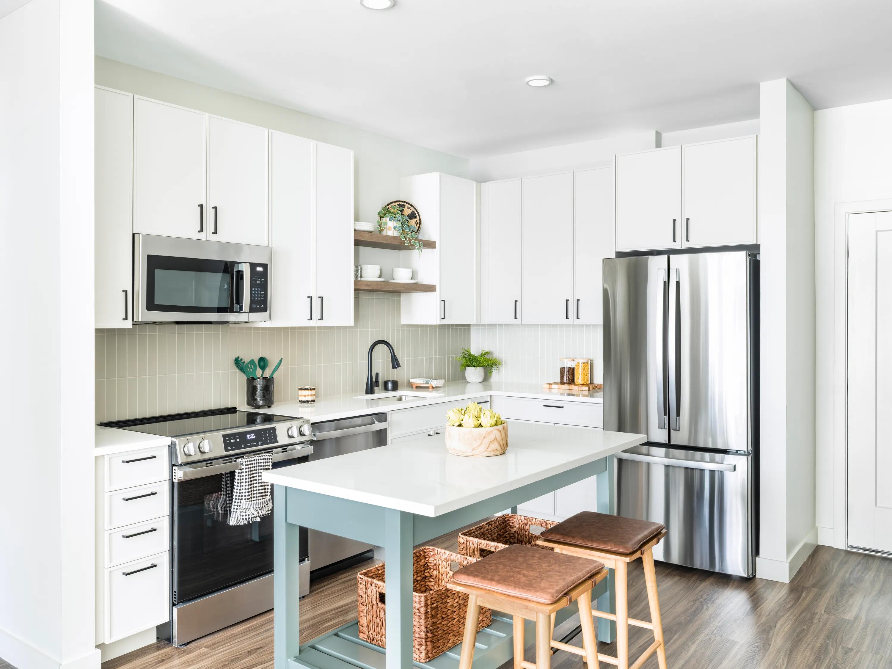 kitchen with stainless steel appliances and two tone cabinetry modera south shore apartment homes for rent in marshfield ma