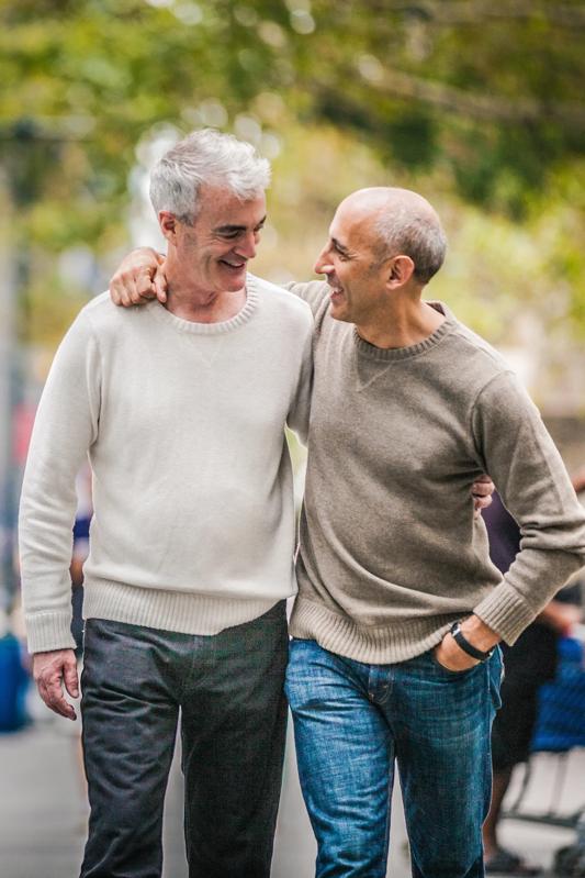 two older men walking and embracing modera art park apartments