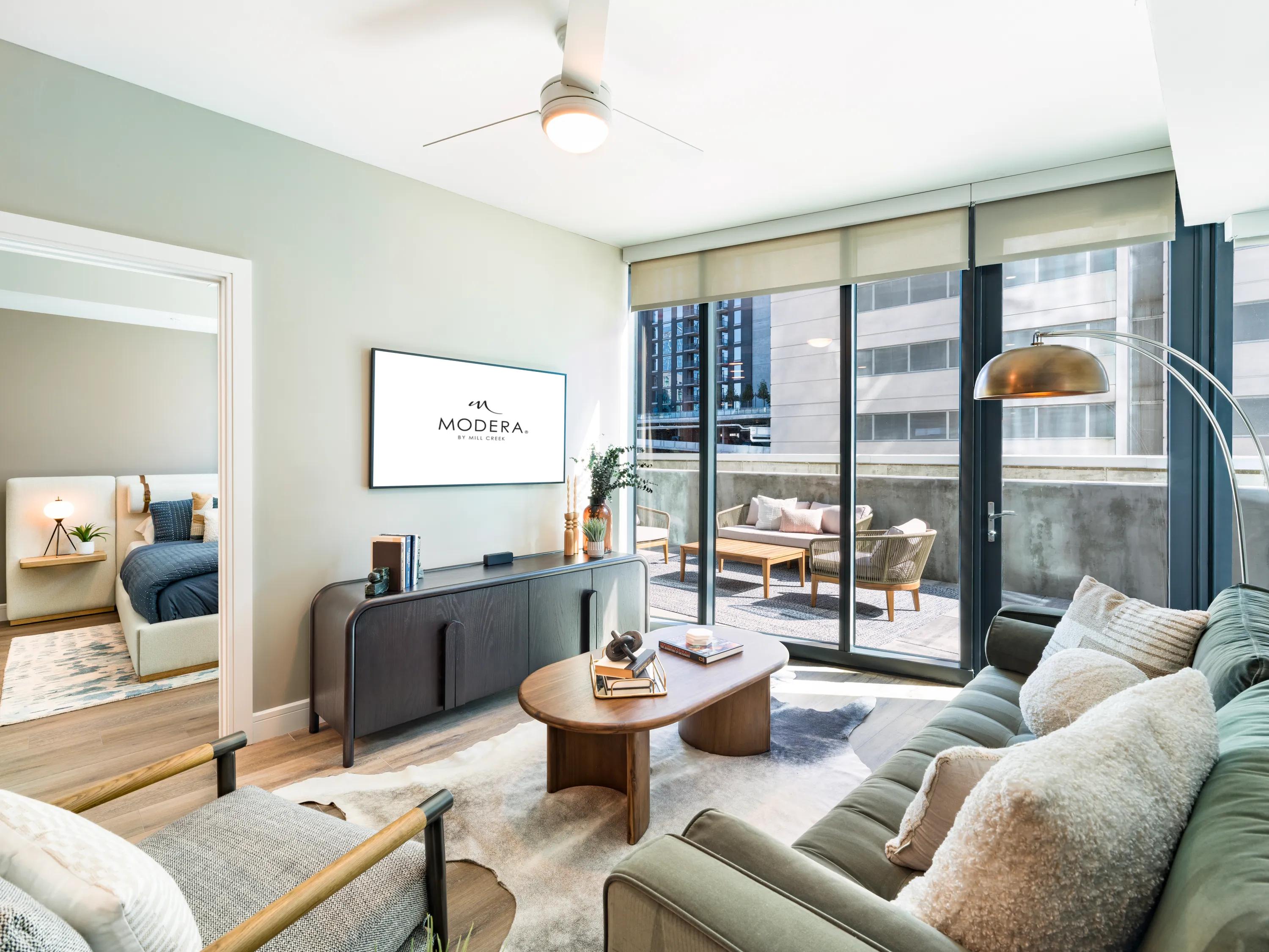 large living area with floor to ceiling windows modera mcgavock apartments for rent in nashville tn