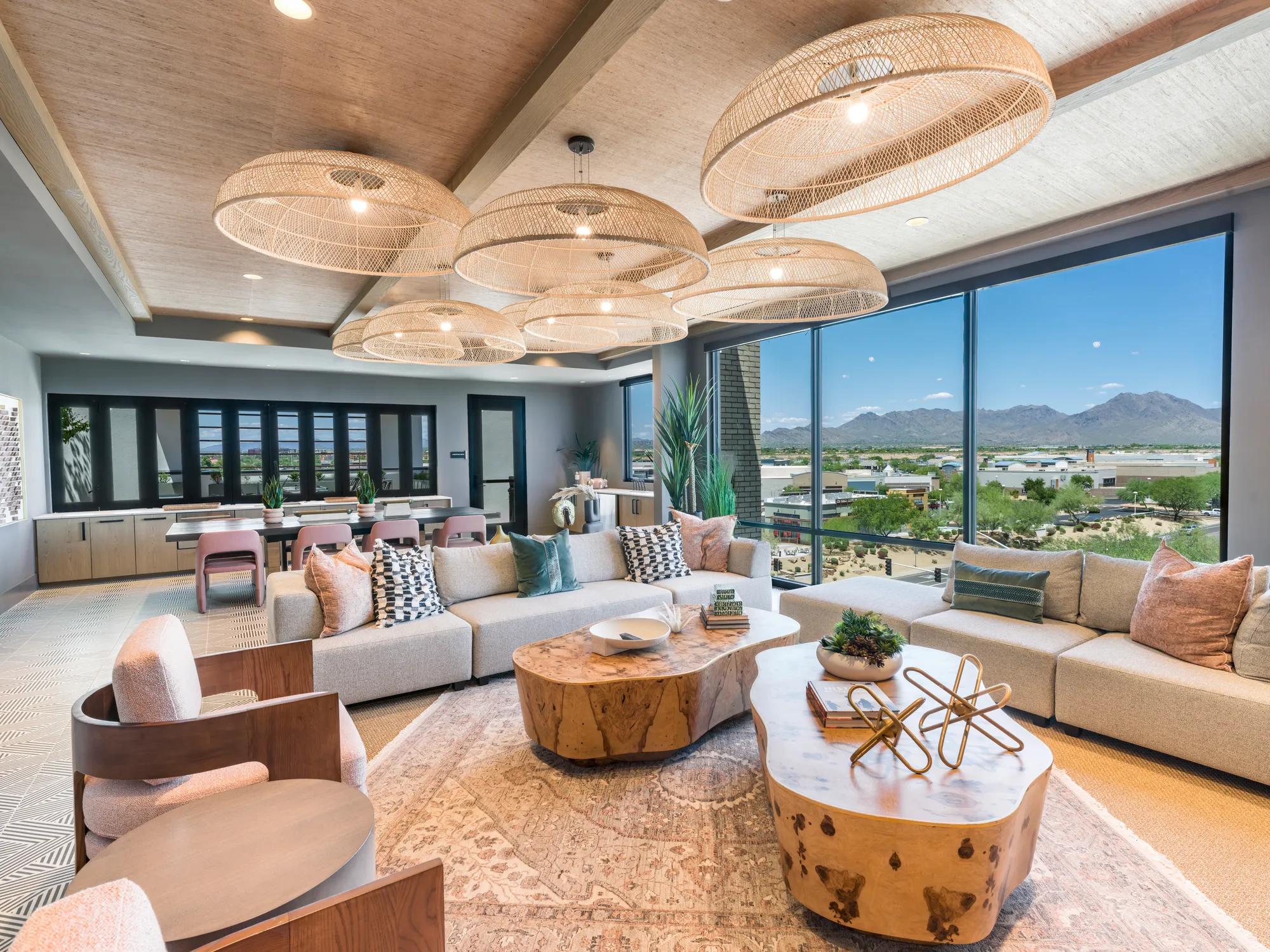 seating with large light fixtures and mountain views with kitchen at modera scottsdale apartment homes for rent in scottsdale az