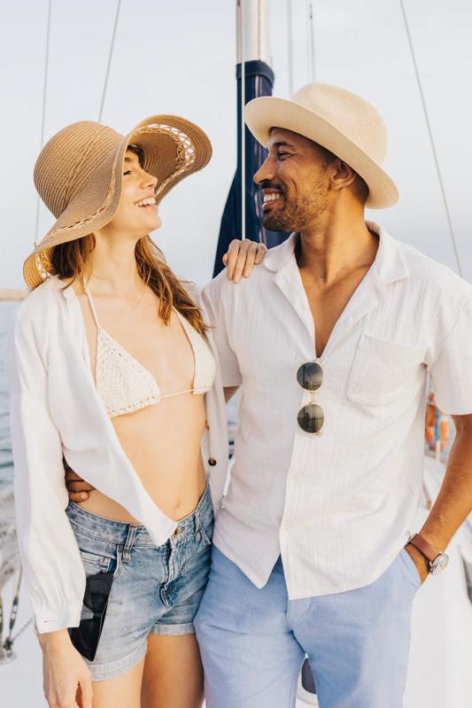 young couple on boat wearing swim suits and and cover ups modera encore fl tampa apartments