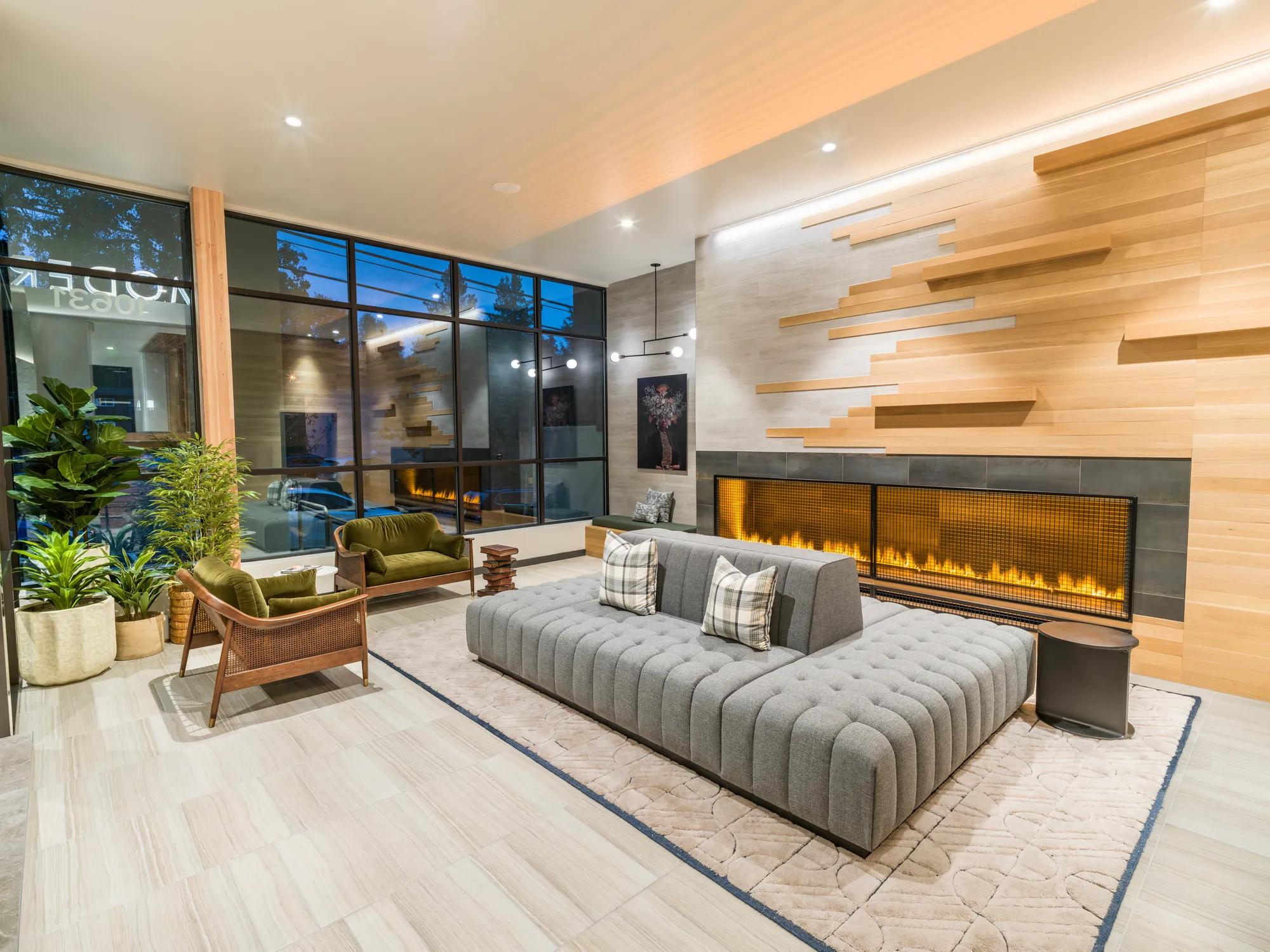 clubhouse seating area with games and fireplace modera northgate apartment homes for rent in seattle wa