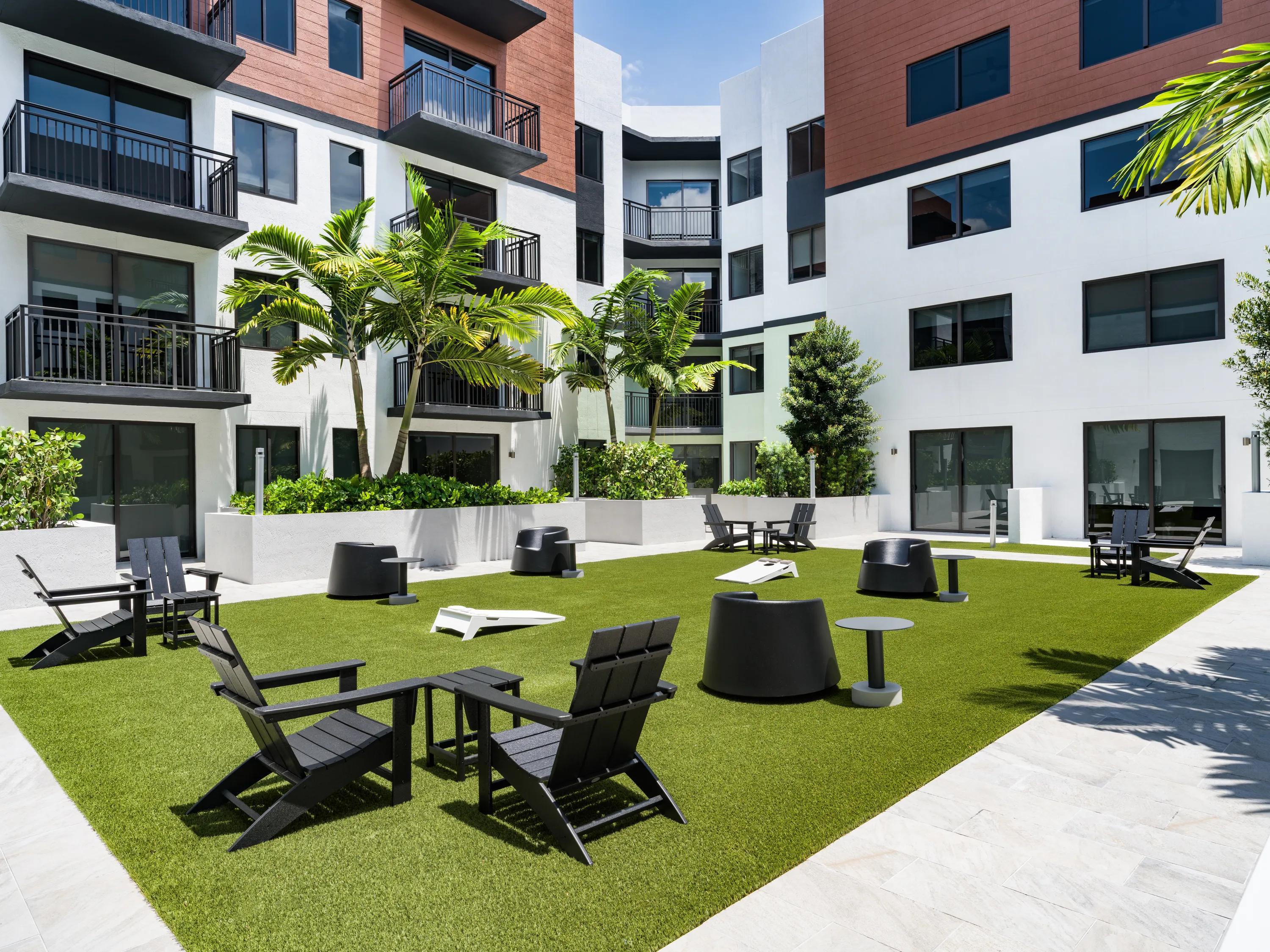 courtyard with Adirondack seating modera coral springs phase 2 apartments in coral springs fl