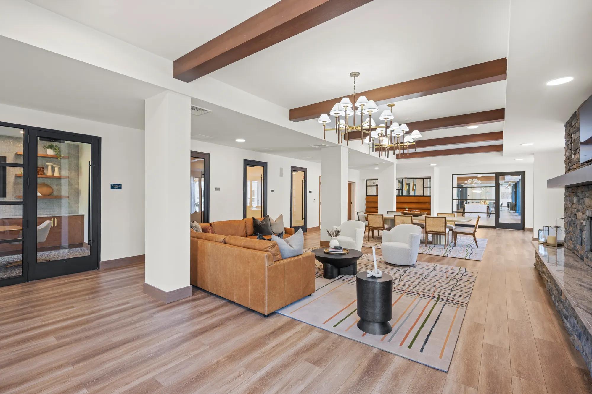 clubroom looking onto private conference rooms with tasteful decorations at modera newton apartment homes for rent in ma