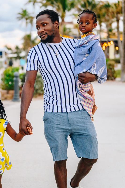 young father carrying daughter on hip modera encore fl tampa apartments