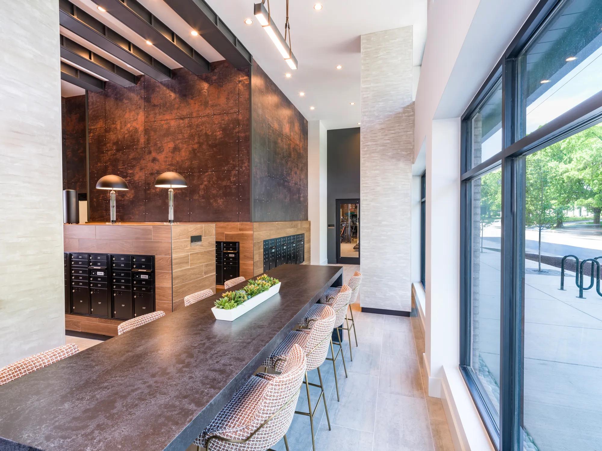 mailroom and seating area on long table modera loso apartment homes for rent in charlotte nc