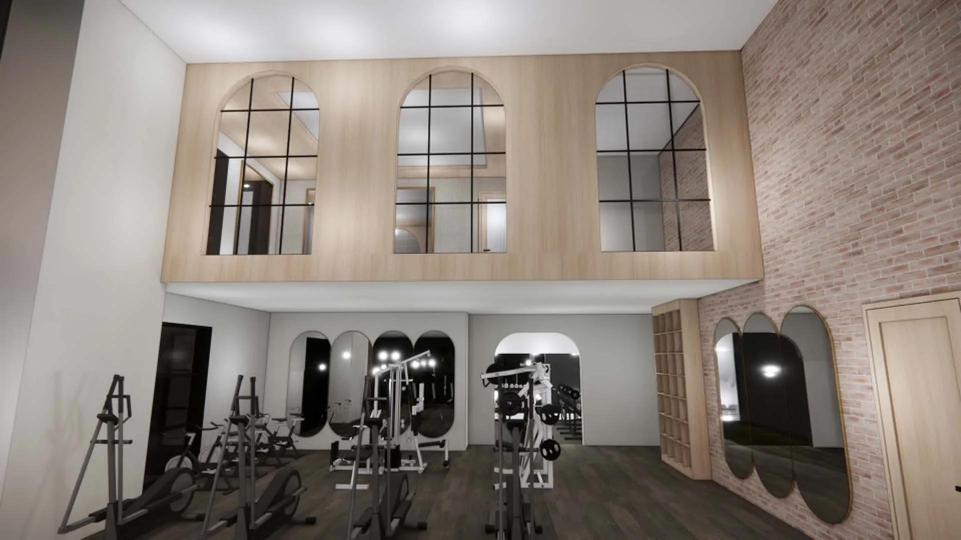 two story fitness center with brick wall at modera university park apartment homes for rent in denver co