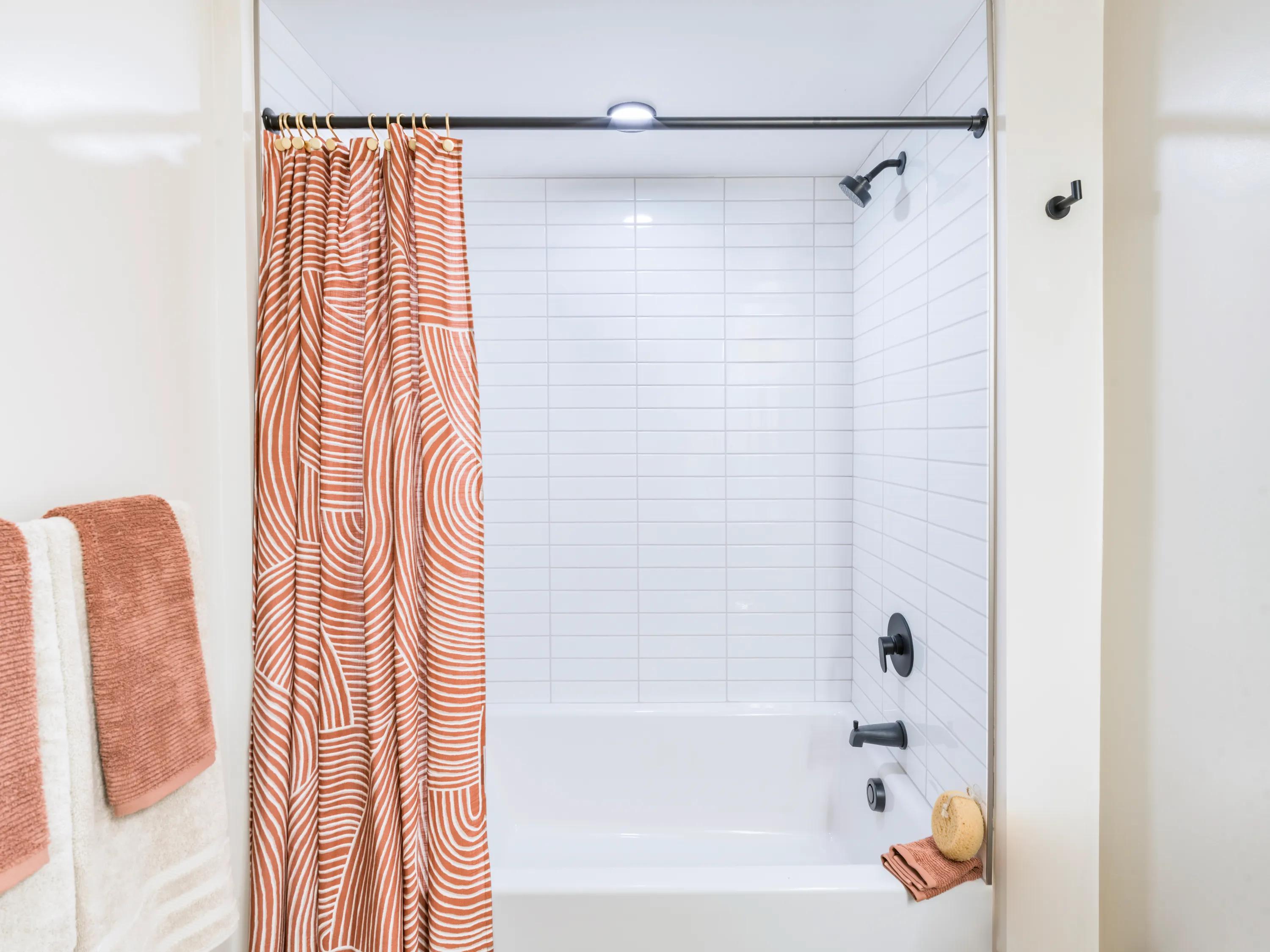 tiled bathtub with tasteful curtain modera reserve apartment homes for rent in scottsdale az