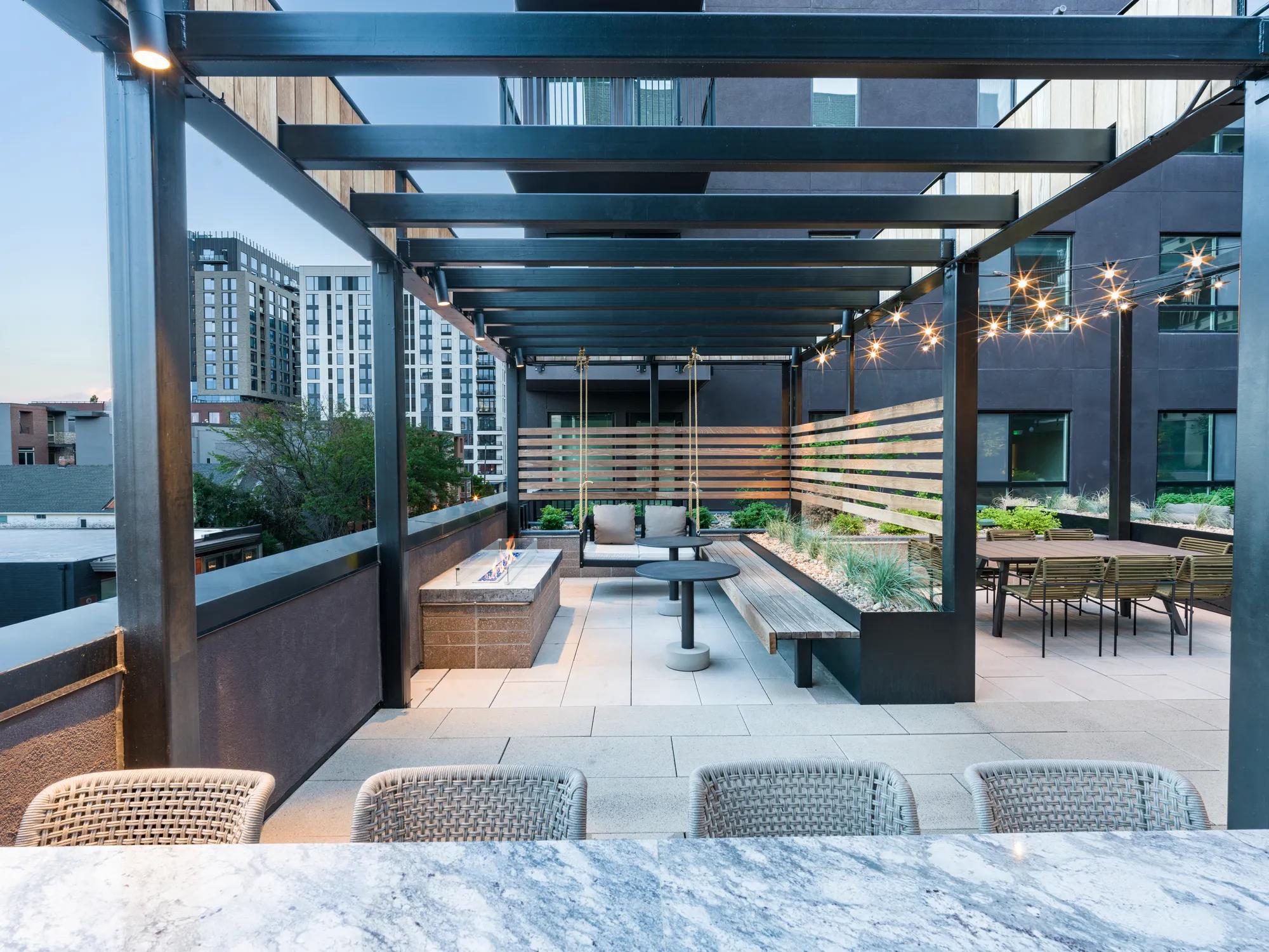 firepit and work from home space in courtyard with stylish finishes and string lights modera golden triangle apartment homes for rent in denver co