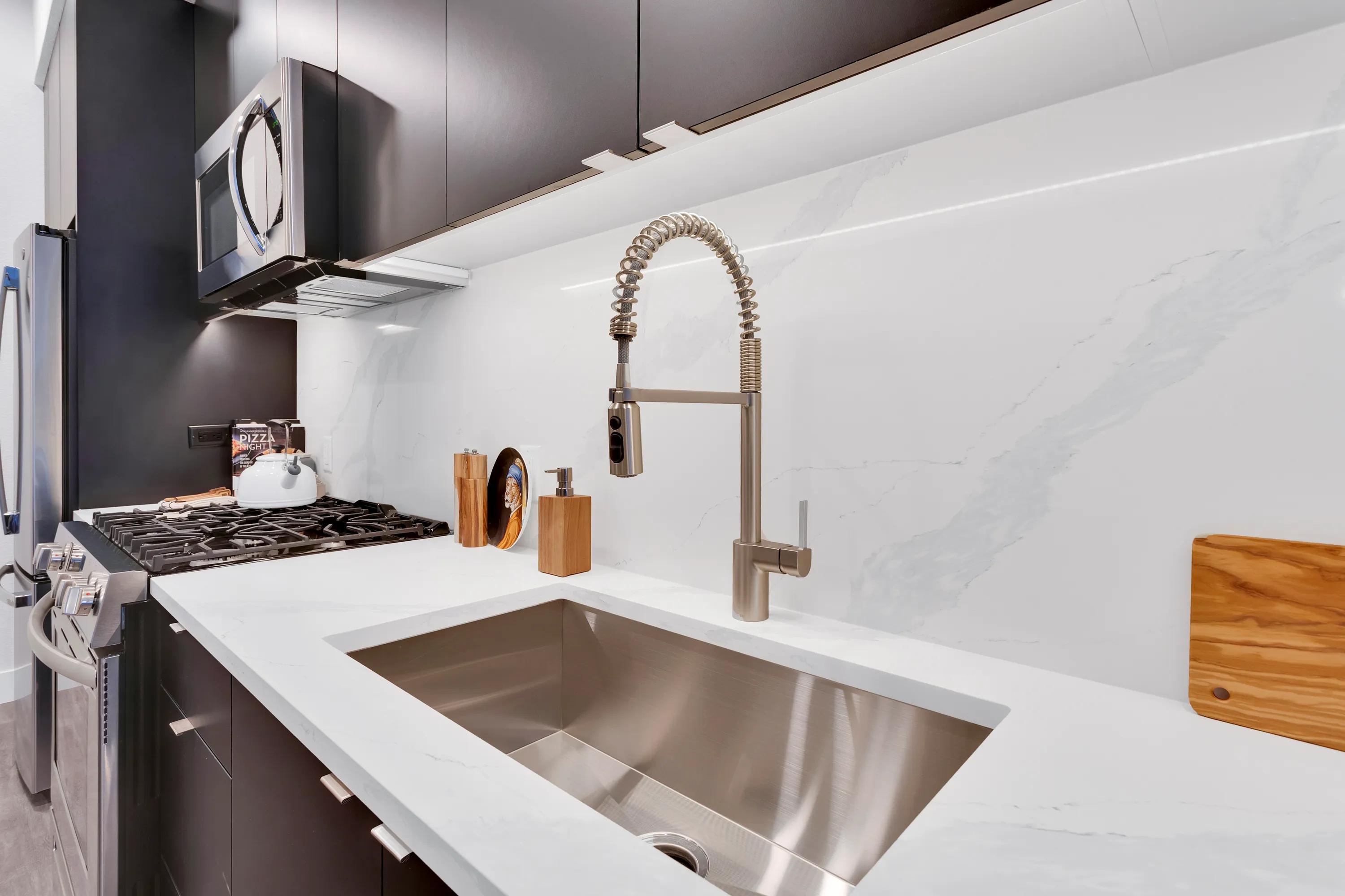 Kitchen island featuring drop-in single basin sink modera art park denver co