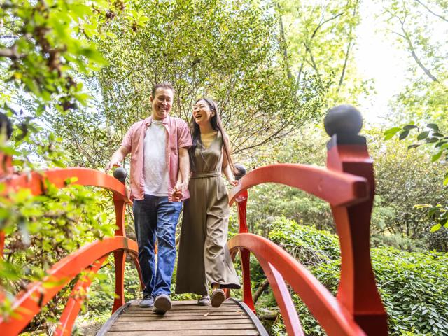 Husband and wife walking through beautiful japanese zen garden
