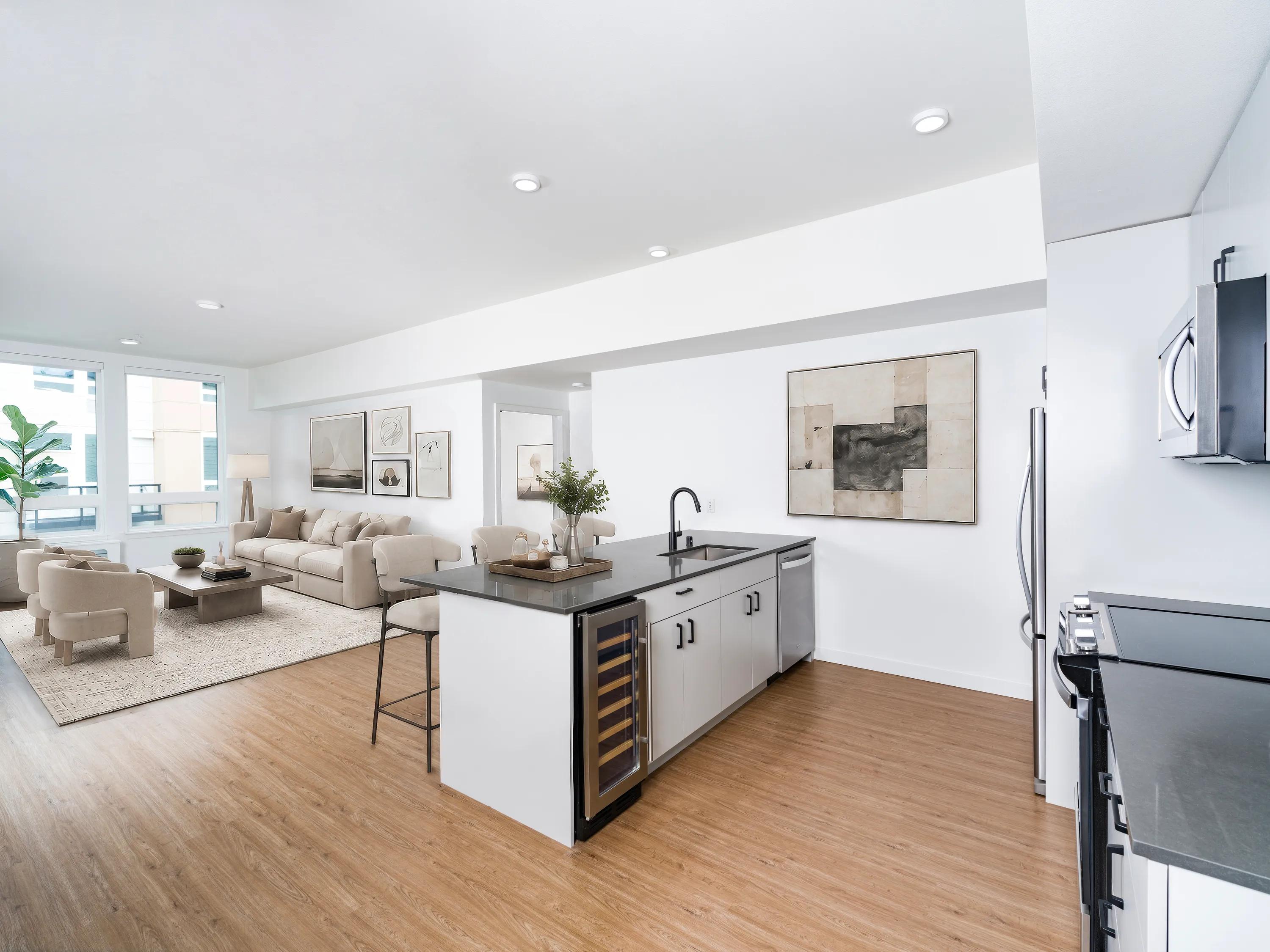 kitchen with wine fridge and island virtually staged looking onto living room