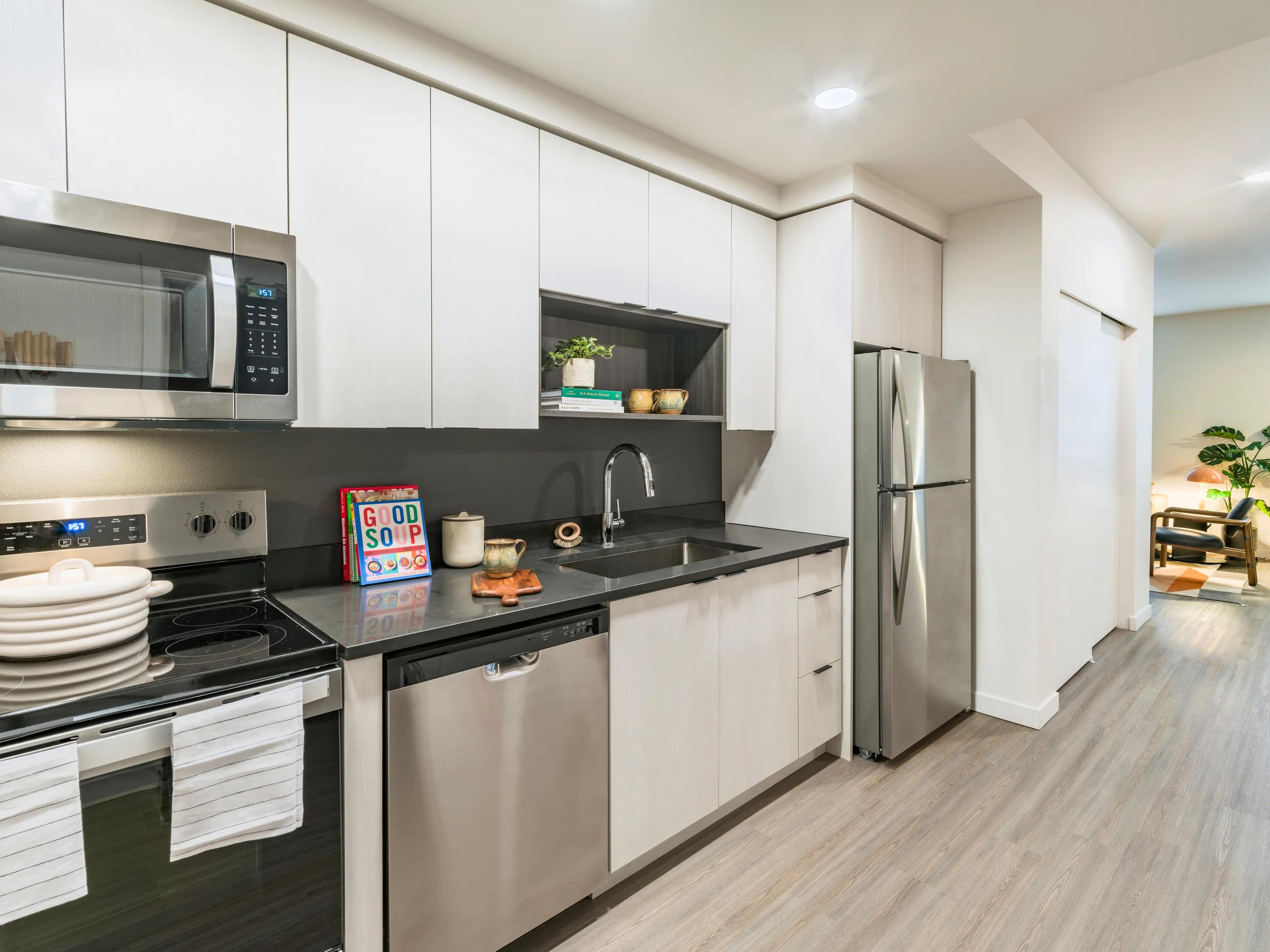 kitchen with granite countertops, island, stainless steel appliances, and more