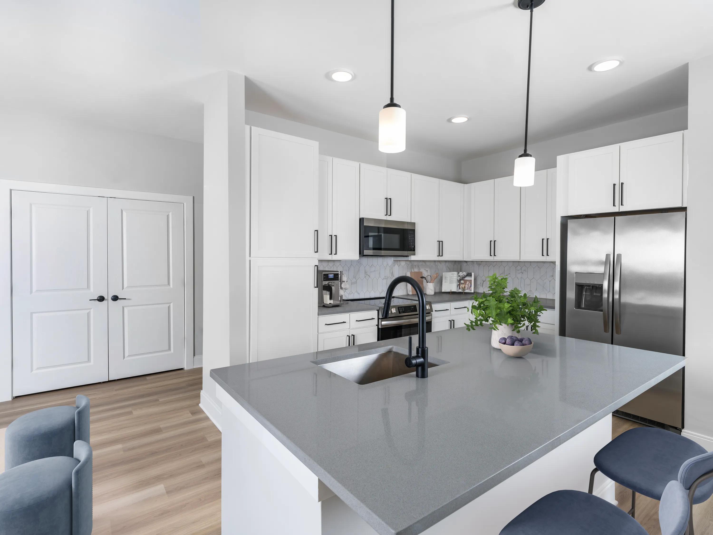 large kitchen island in kitchen with pendant lighting adjacent to large closet modera liberty row apartment homes for rent in in charlotte nc