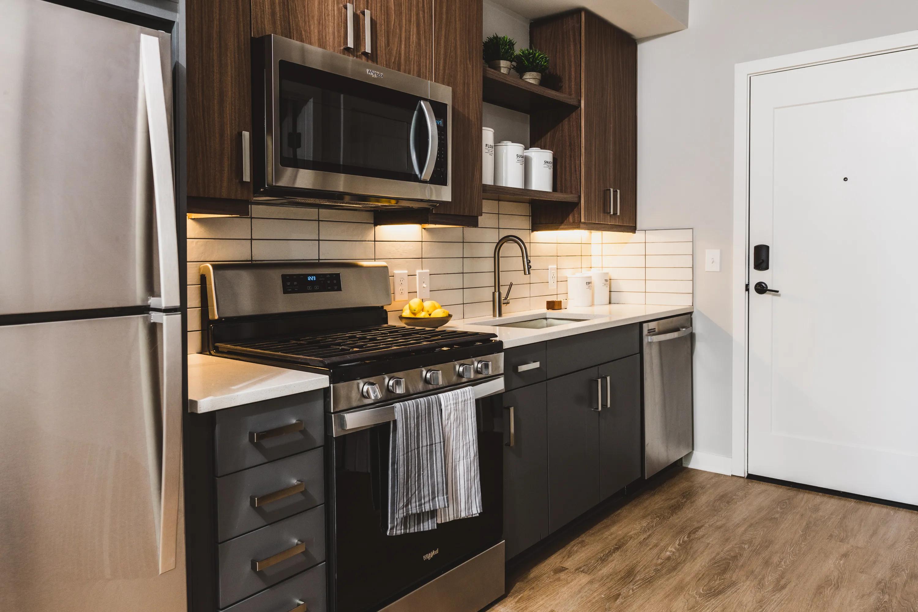 Kitchen showing refrigerator, microwave, and dishwasher